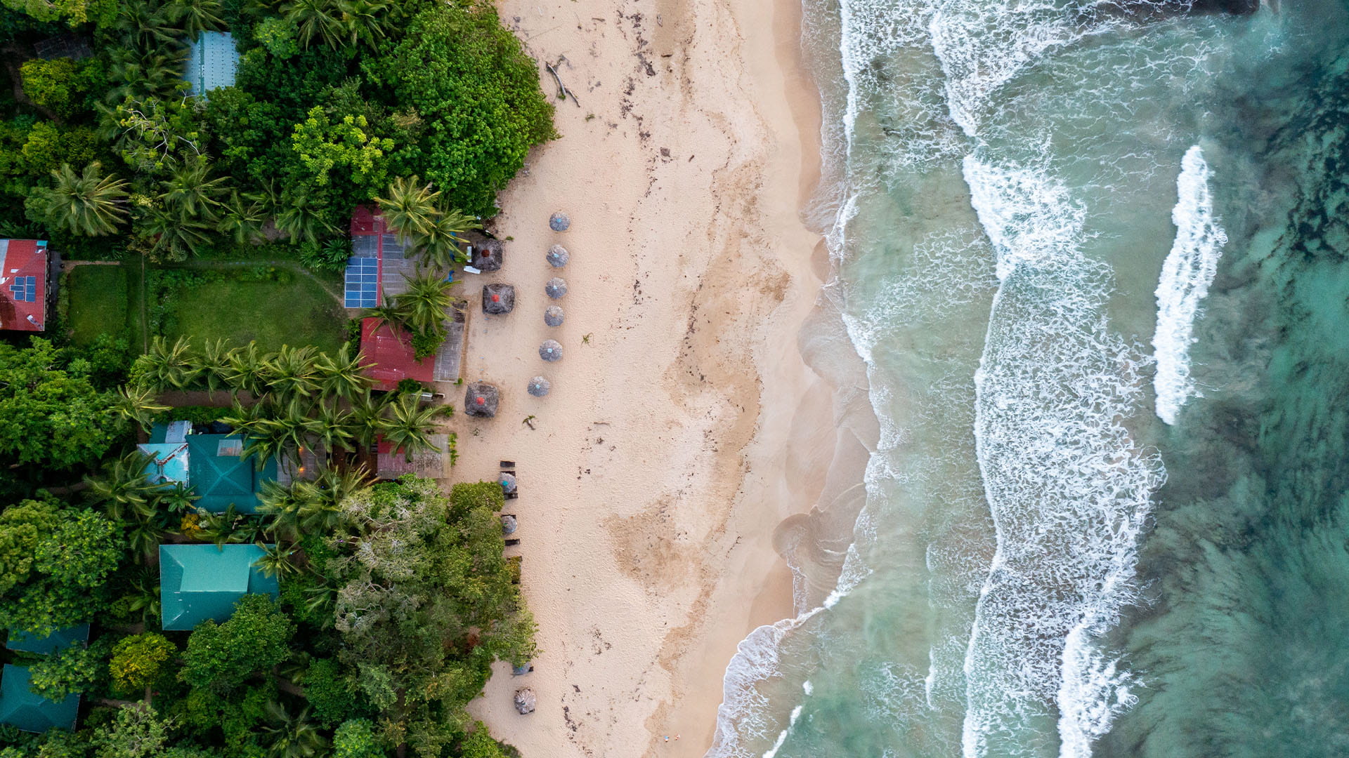 aerial view of the pristine white sands and crashing waves of the Bocas del Toros beach in Panama