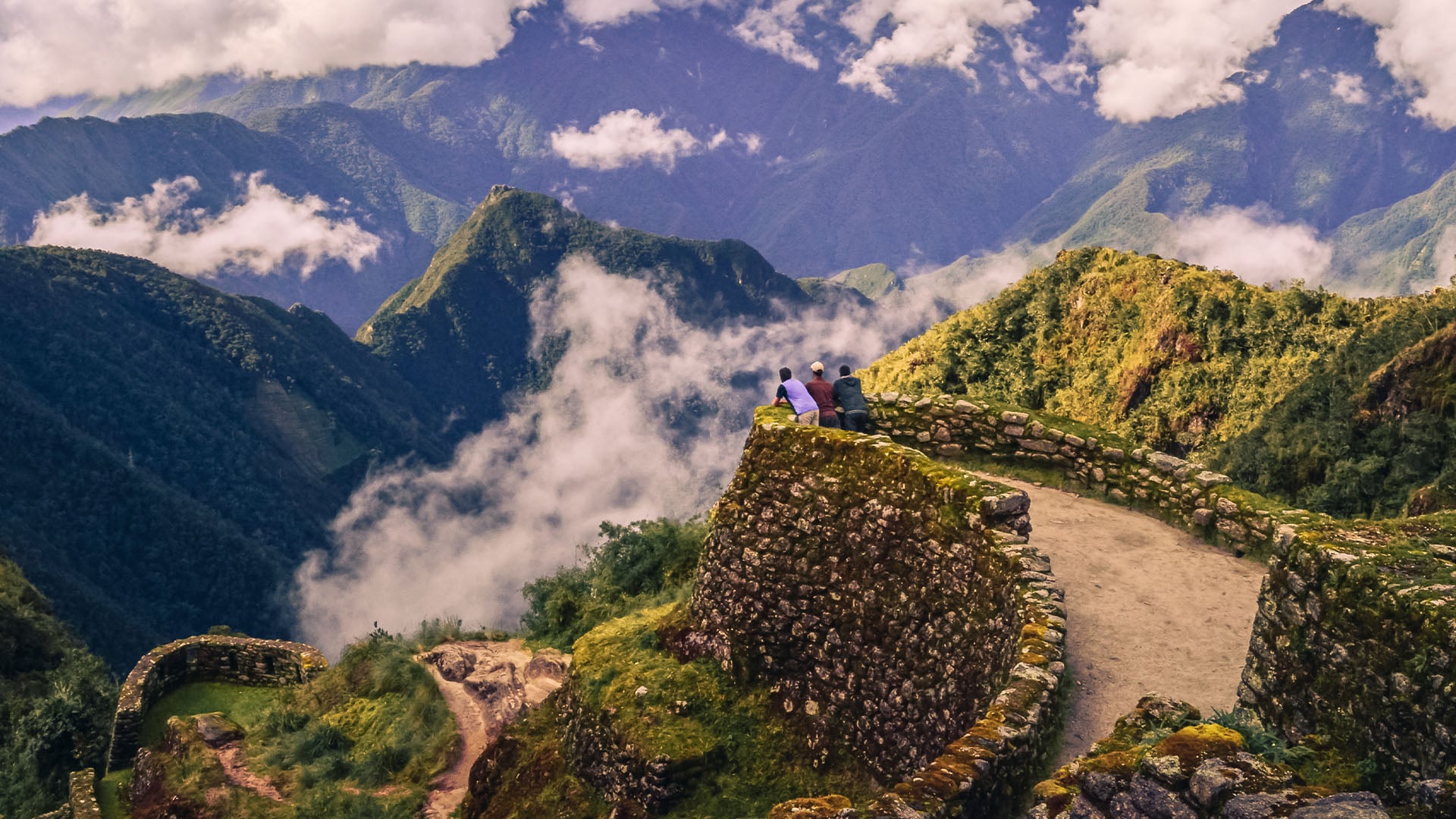 A group of men watching from an ancient lookout along the Inca Trail