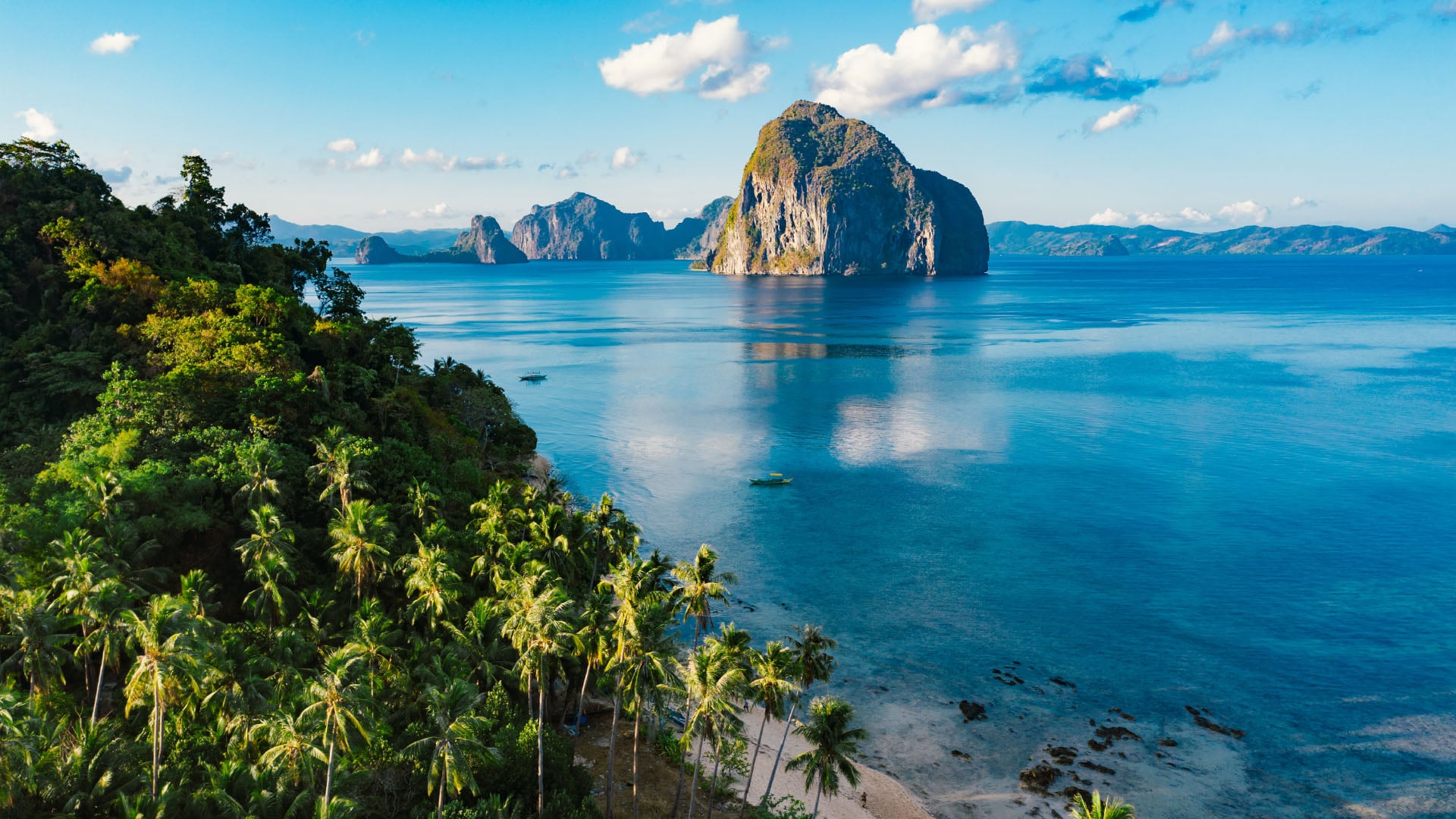 Aerial view of beach, forest, and ocean in El Nido, Palawan, Philippines.