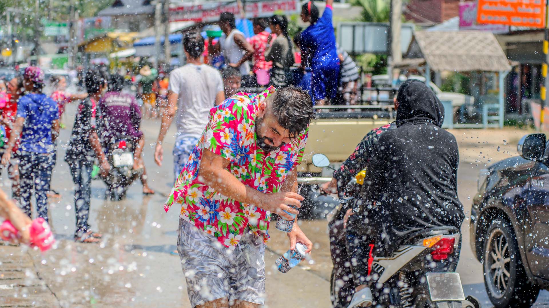 A man getting sprayed for songkran in Thailand