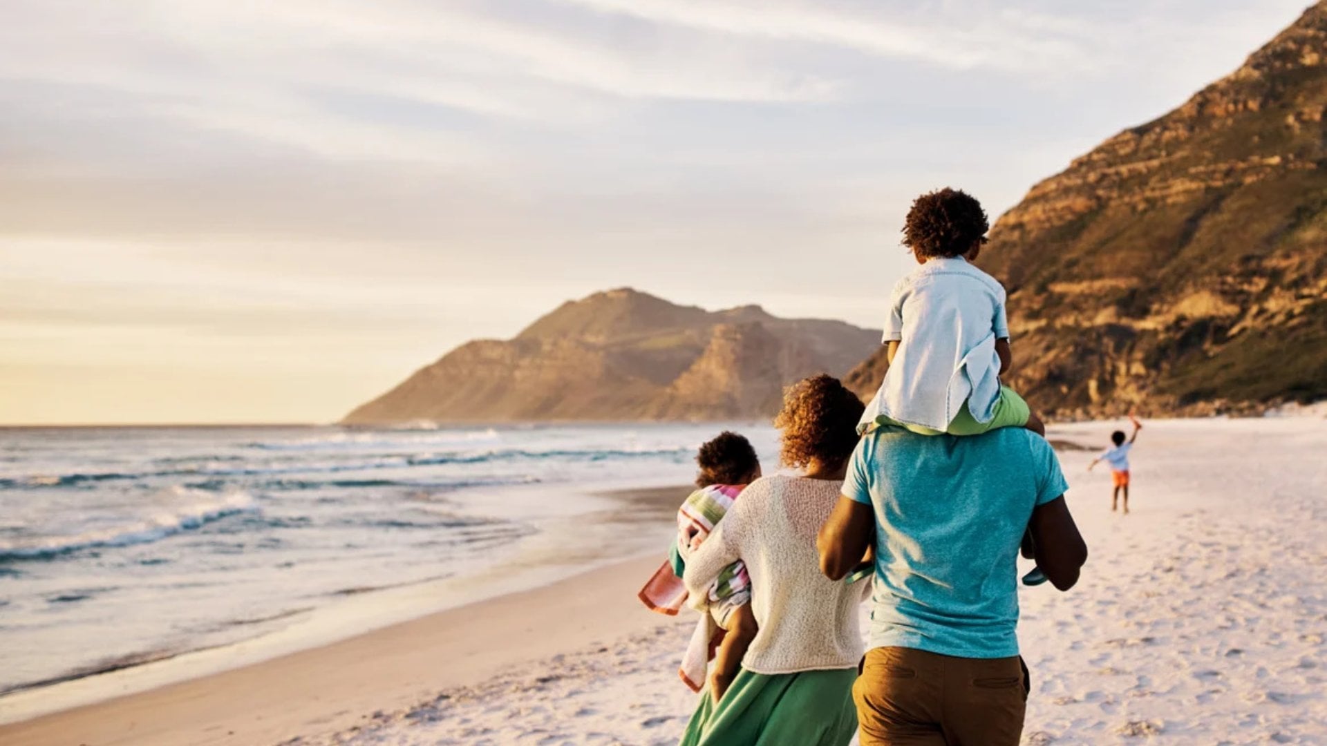 A family walks on the beach