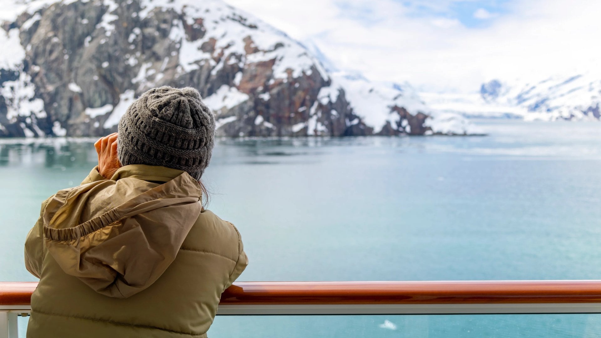 A tourist takes an icy picture from a cruise ship