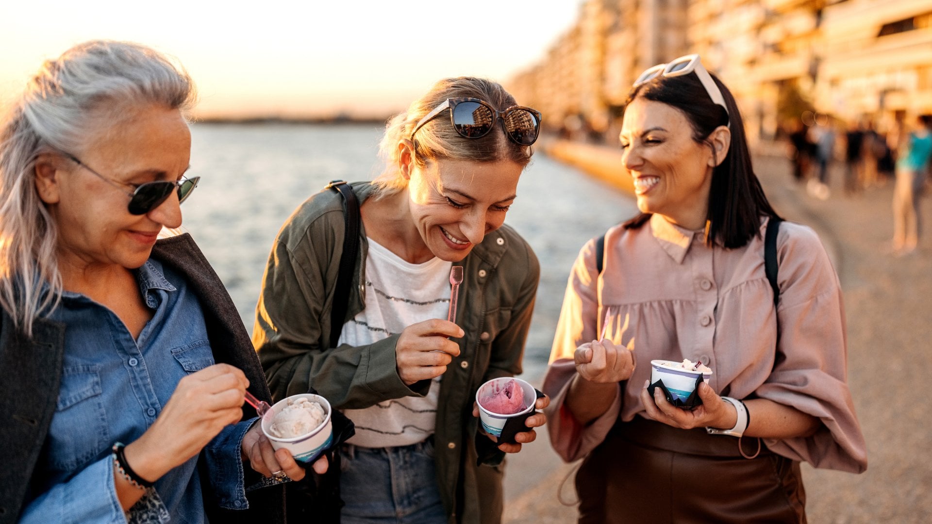 Friends share ice cream on the beach