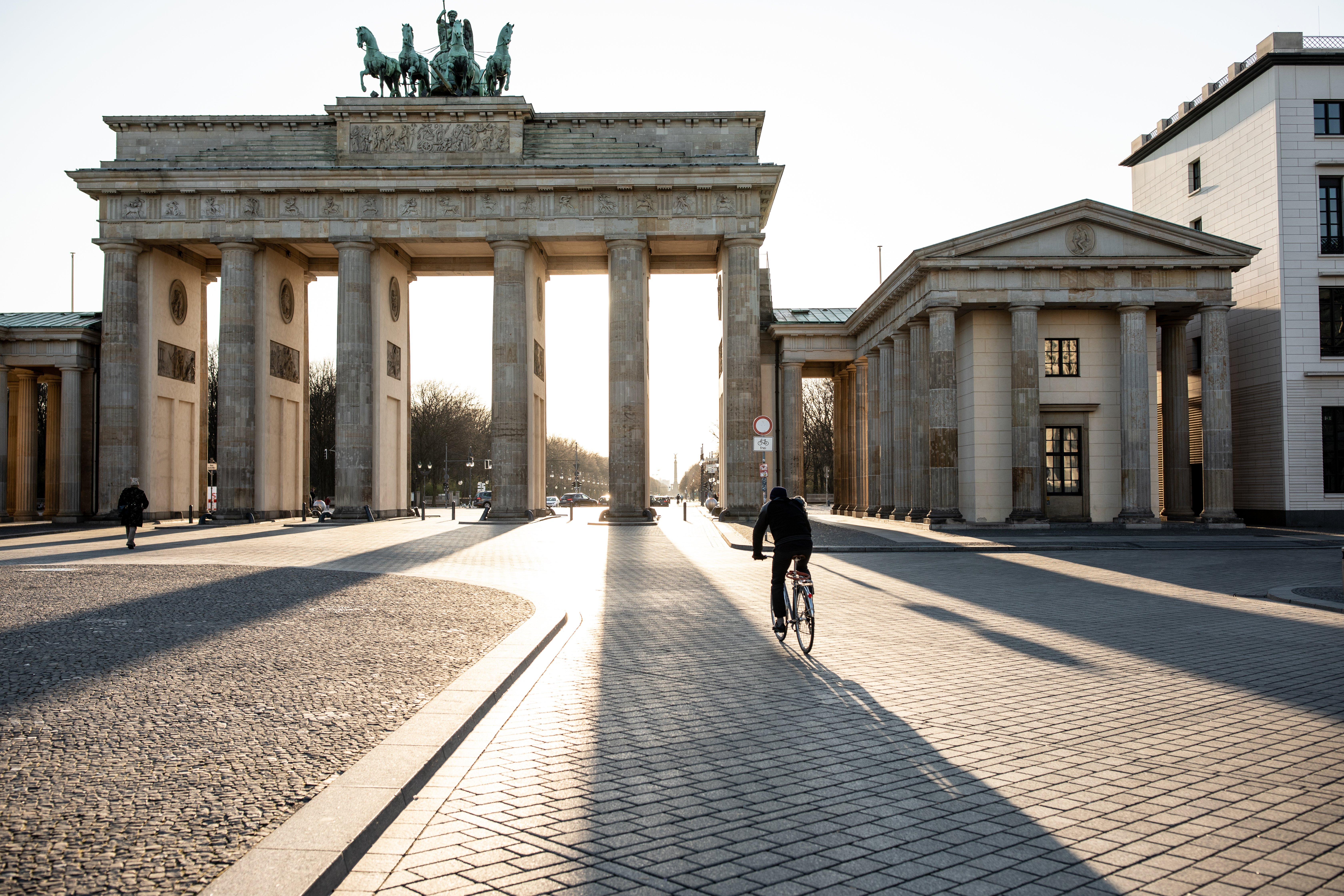 Lone biker riding past Berlin's Brandenburg Gate