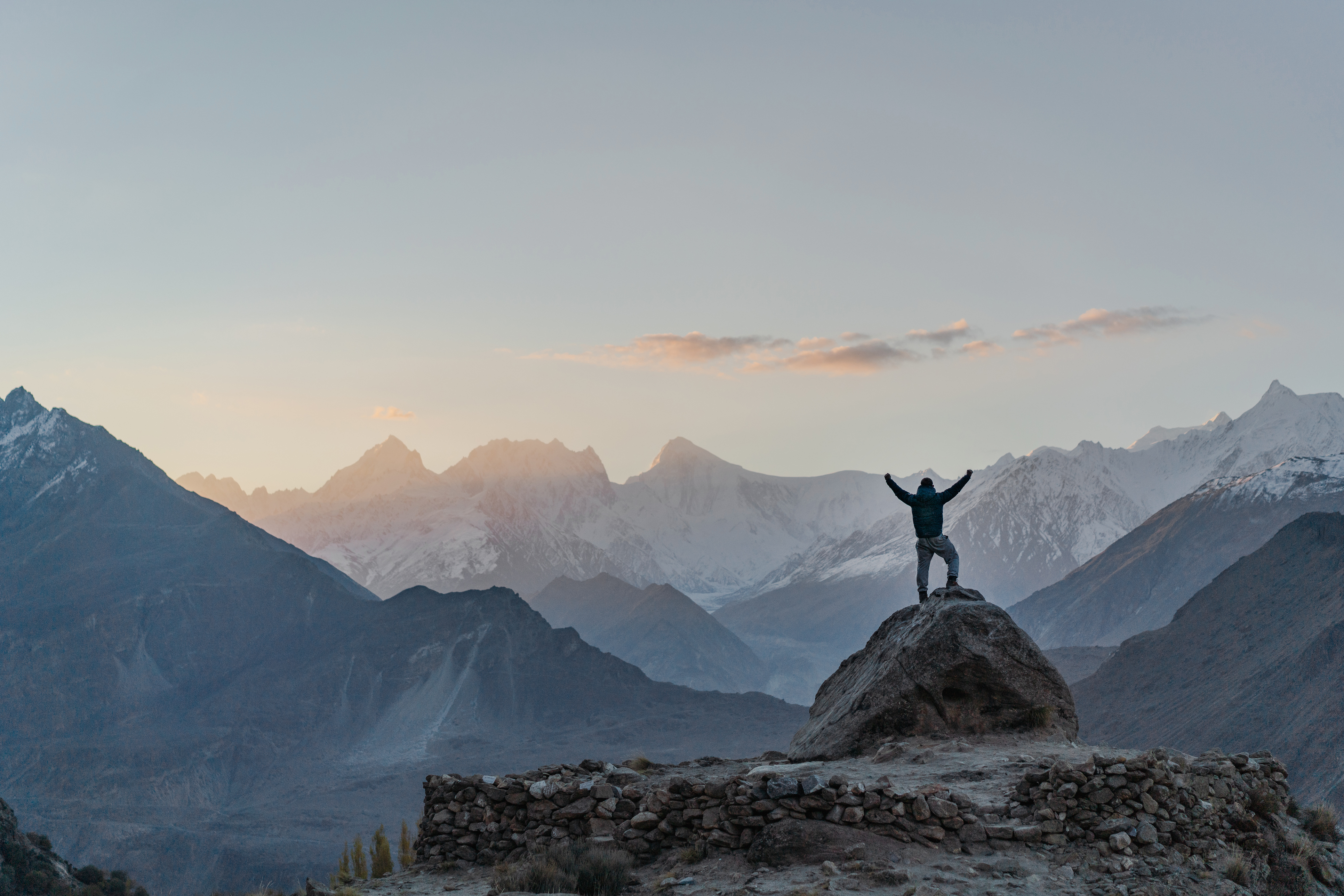 Man standing on rock and looking at river in Himalayas