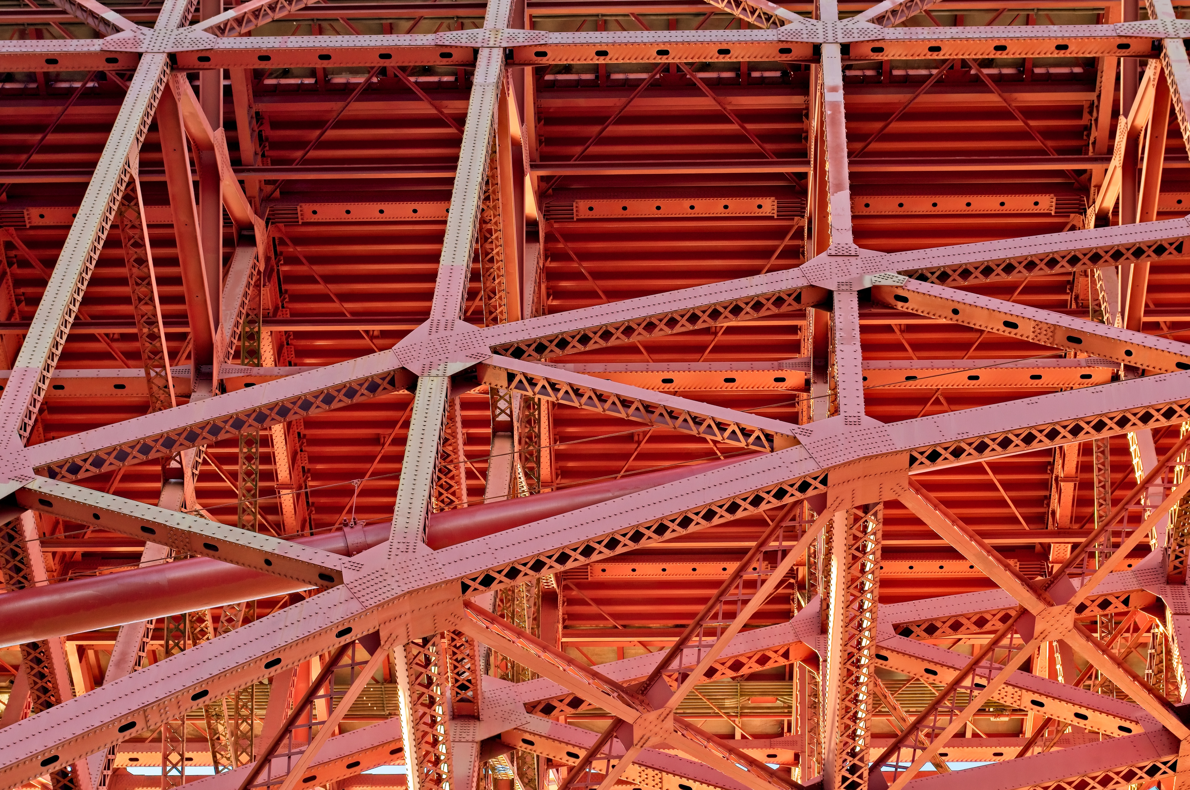 Golden Gate Bridge in afternoon warm light. Girders, beams, deck planking, and rivets showing the details of this engineering marvel.