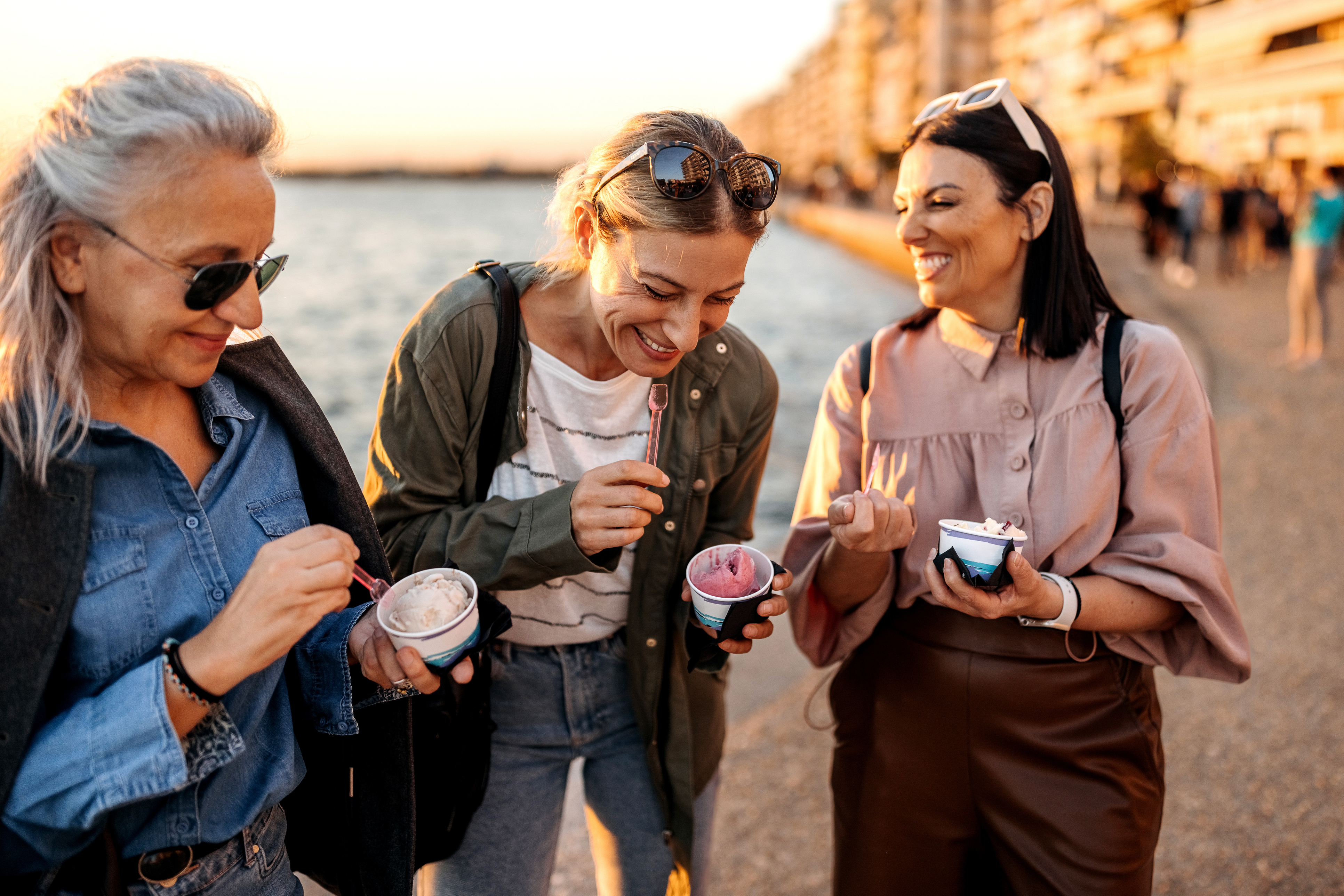 Friends share ice cream on the beach