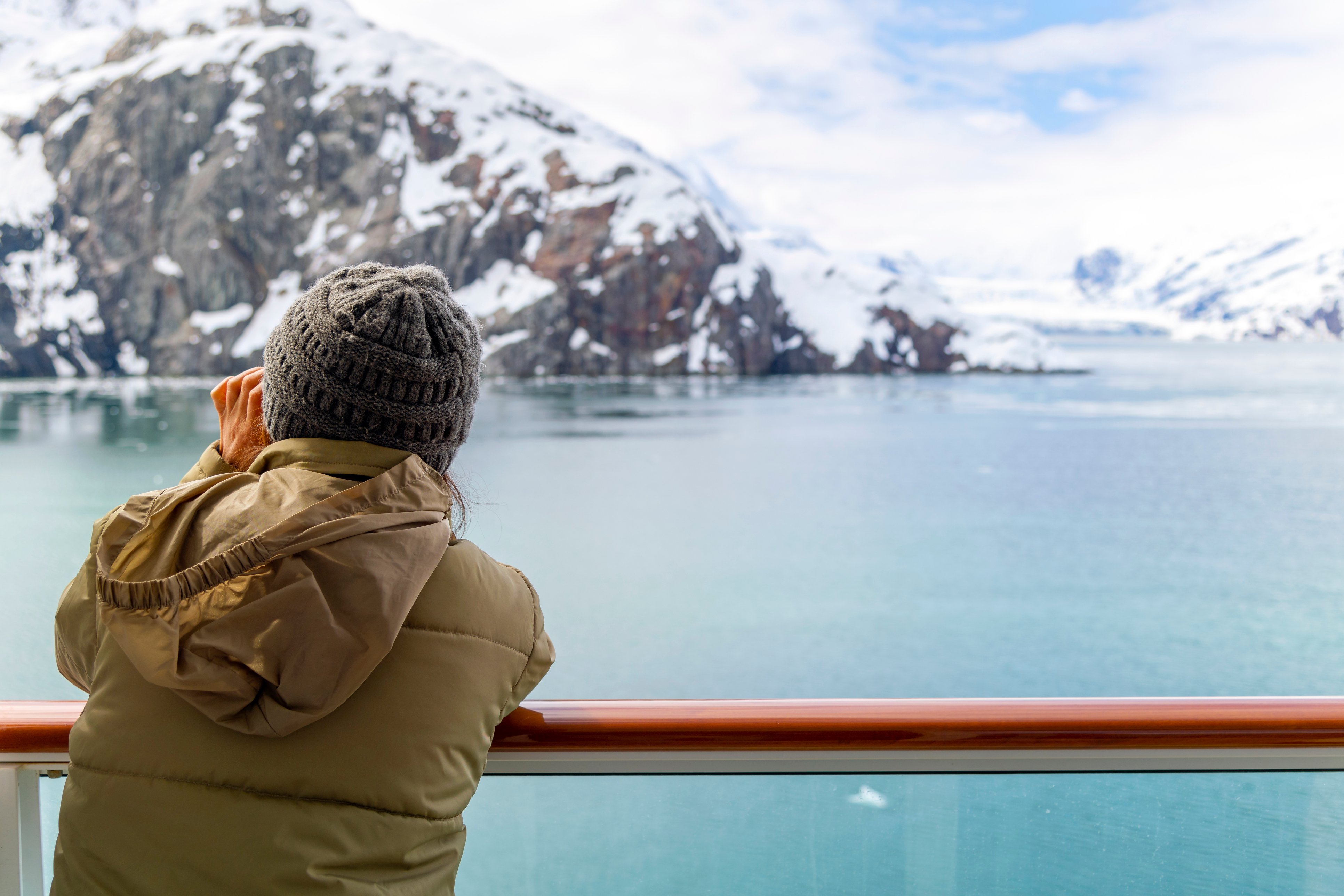 A tourist takes an icy picture from a cruise ship