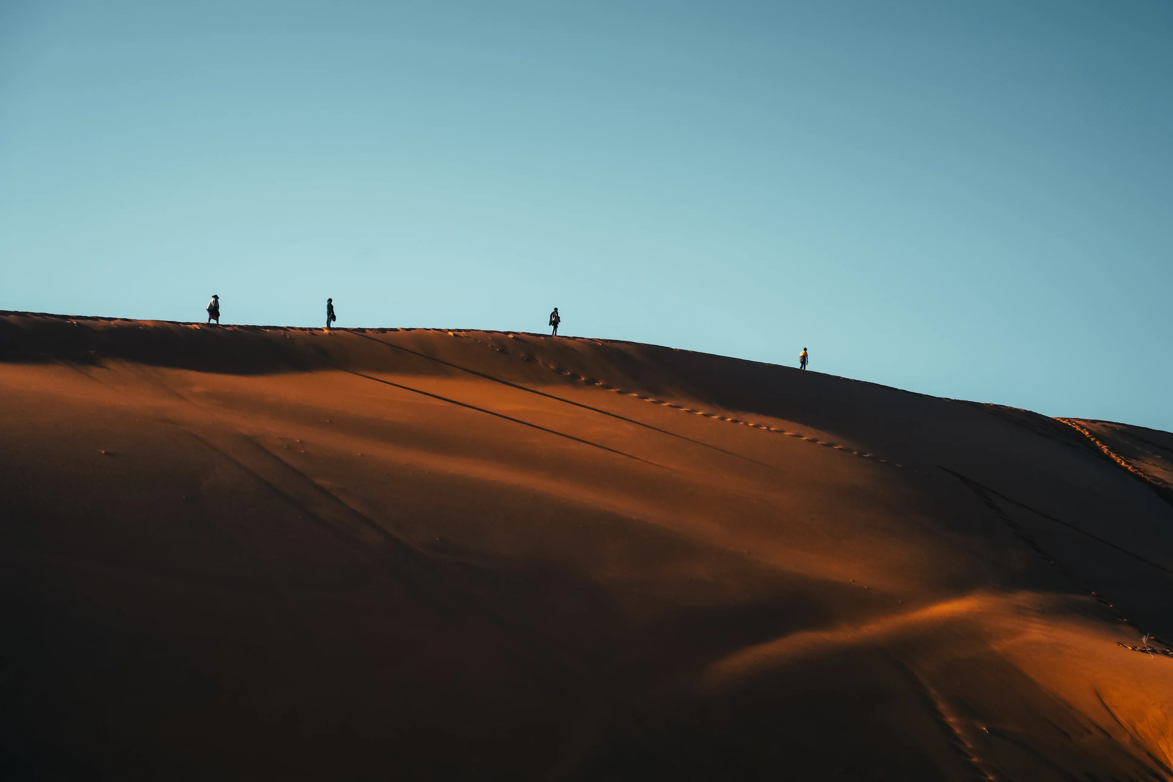 Silhouette tourist walking on Namibia Desert Dune