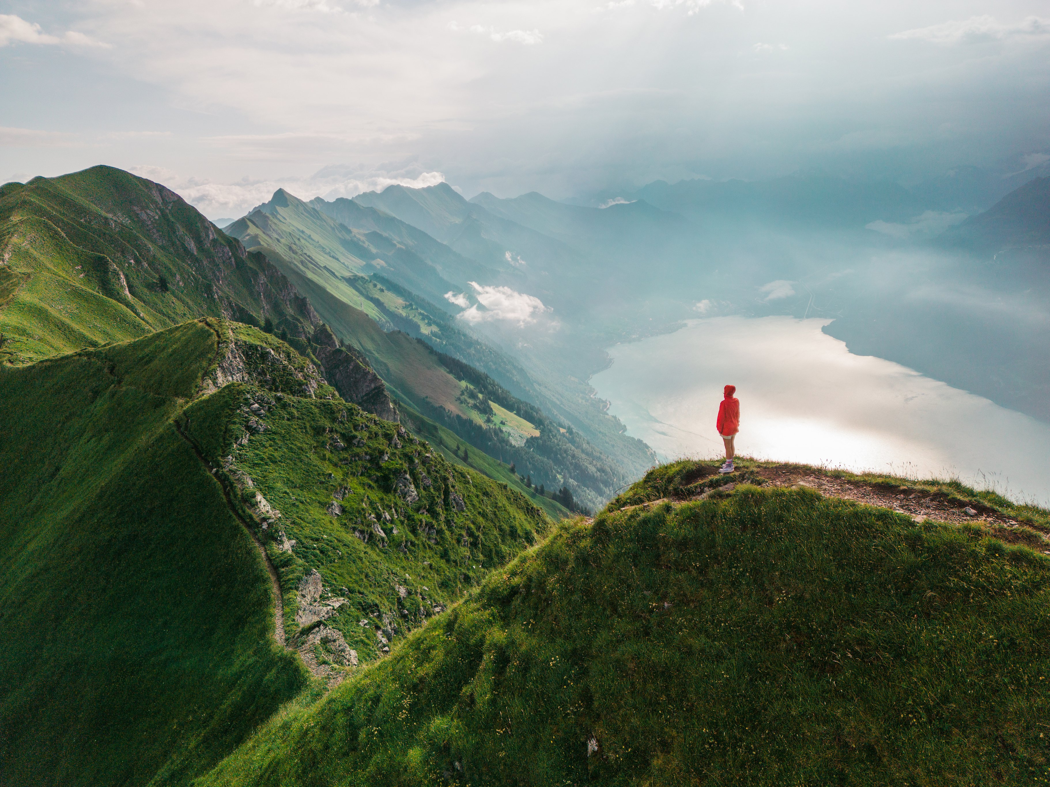 Augstmatthorn mountain, Interlaken, Switzerland Aerial view of woman standing on top of the ridge of Augstmatthorn mountain, Interlaken, Switzerland.