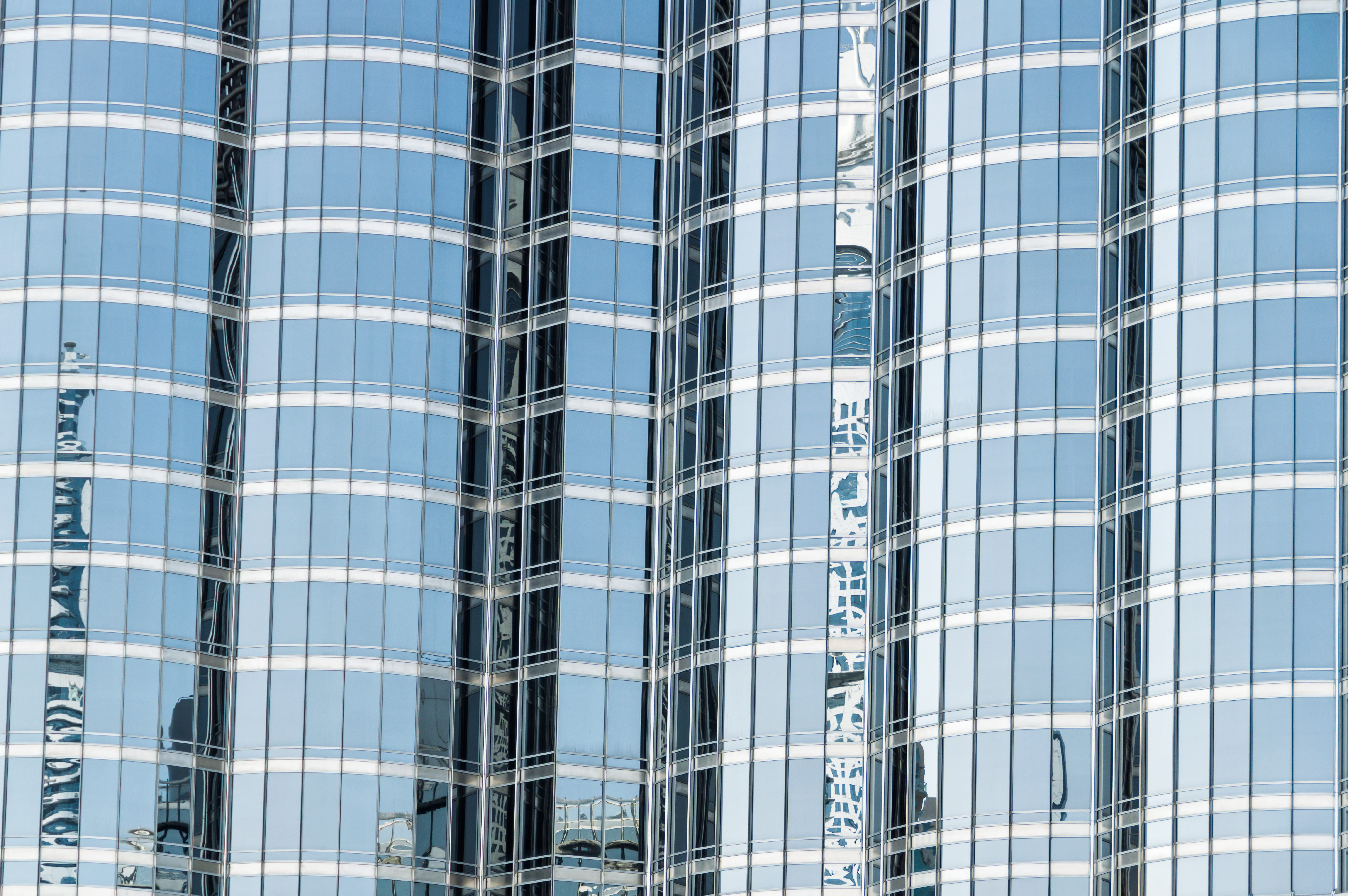 Futuristic office building reflection in Dubai, Abu Dhabi, UAE - Burj Khalifa.