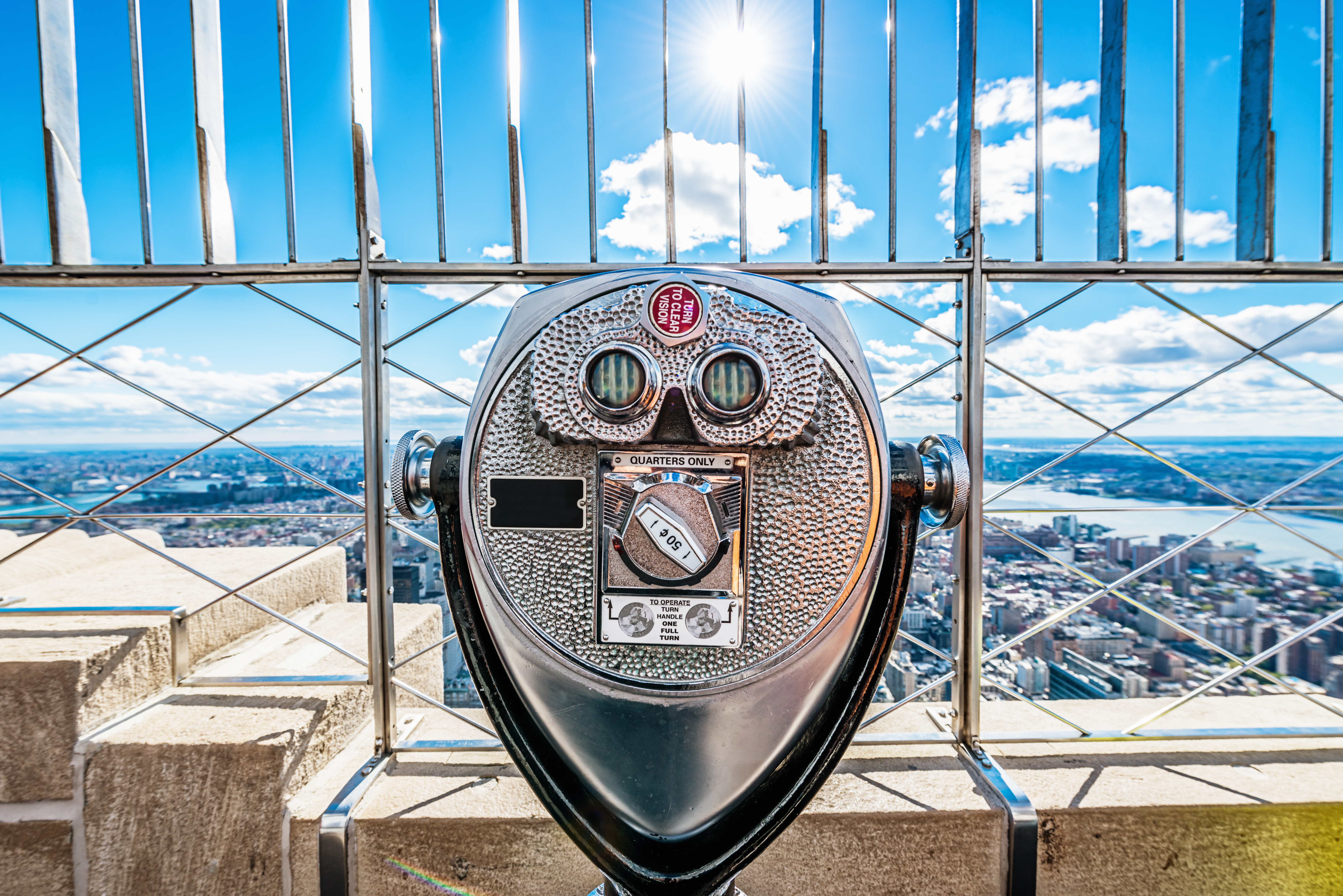 Binoculars and spectacular view over New York City, as seen from the Empire State Building observation dec