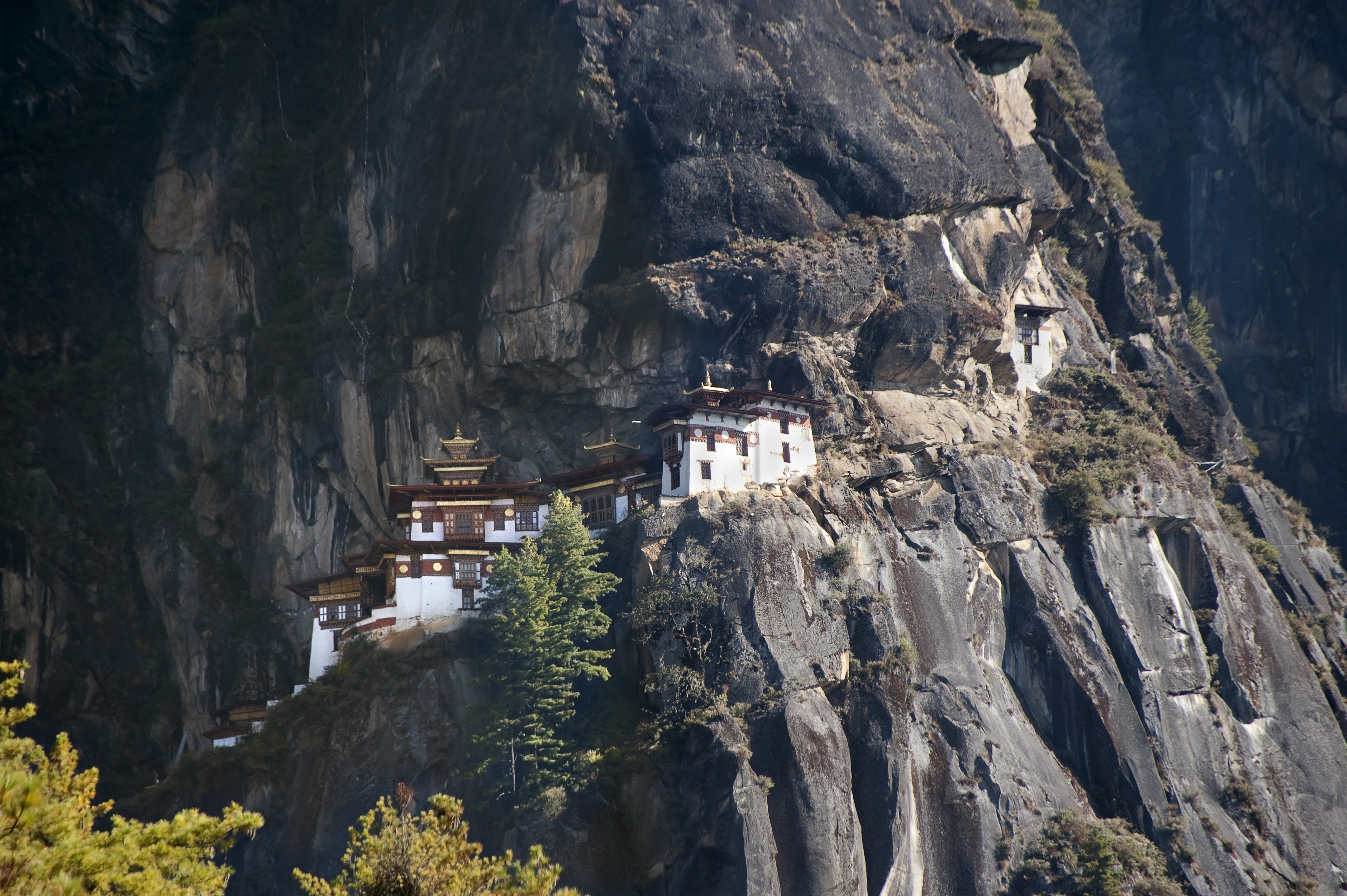 Taktshang, “the Tiger’s Nest” in the Paro Valley, is one of the most sacred sites in Bhutan. The monastery clings to the black rock, overhangeing the valley below by 800 meters (2.600 feet)
