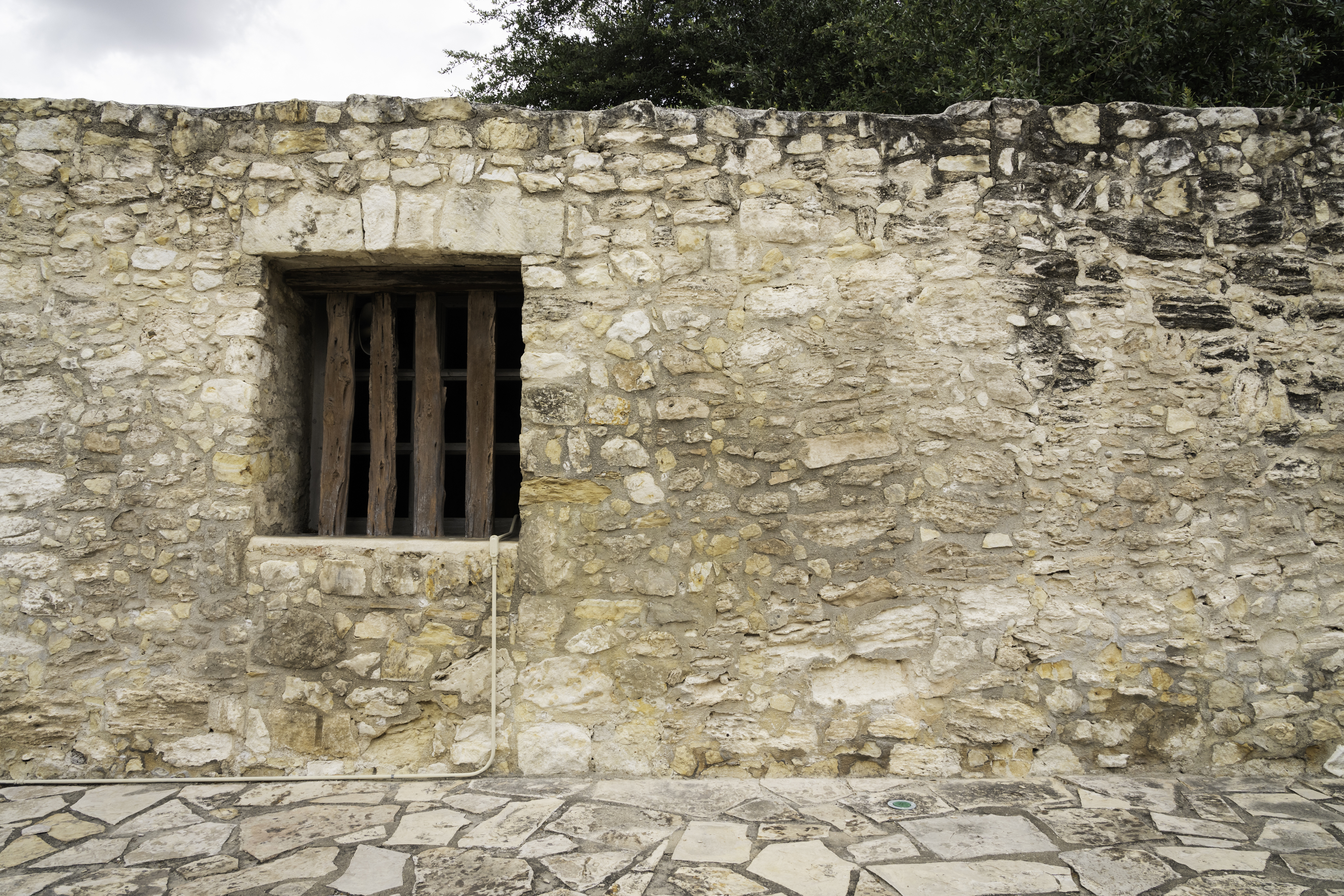 Stone wall with a wooden planks at the Alamo