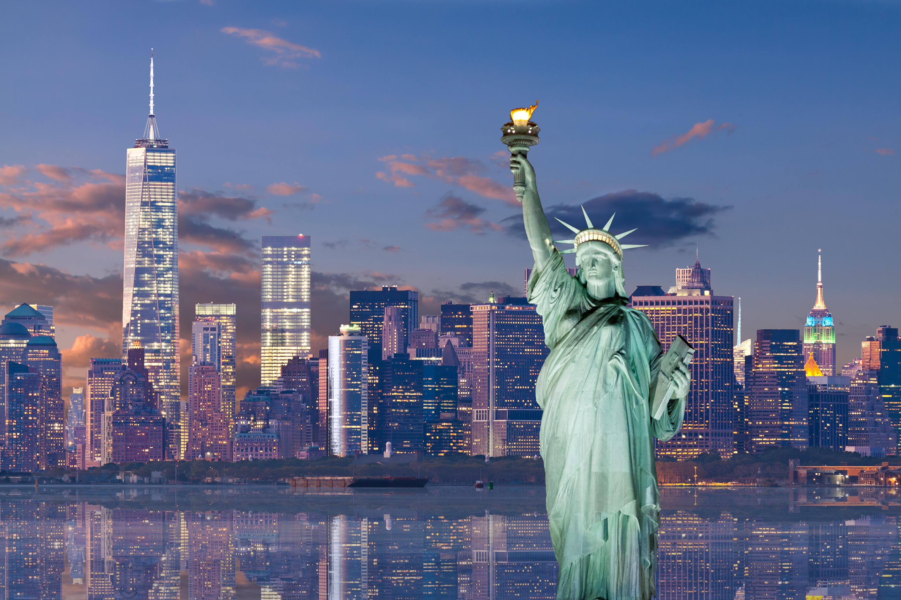 Statue of Liberty and Financial Disrict of Downtown Manhattan at sunset