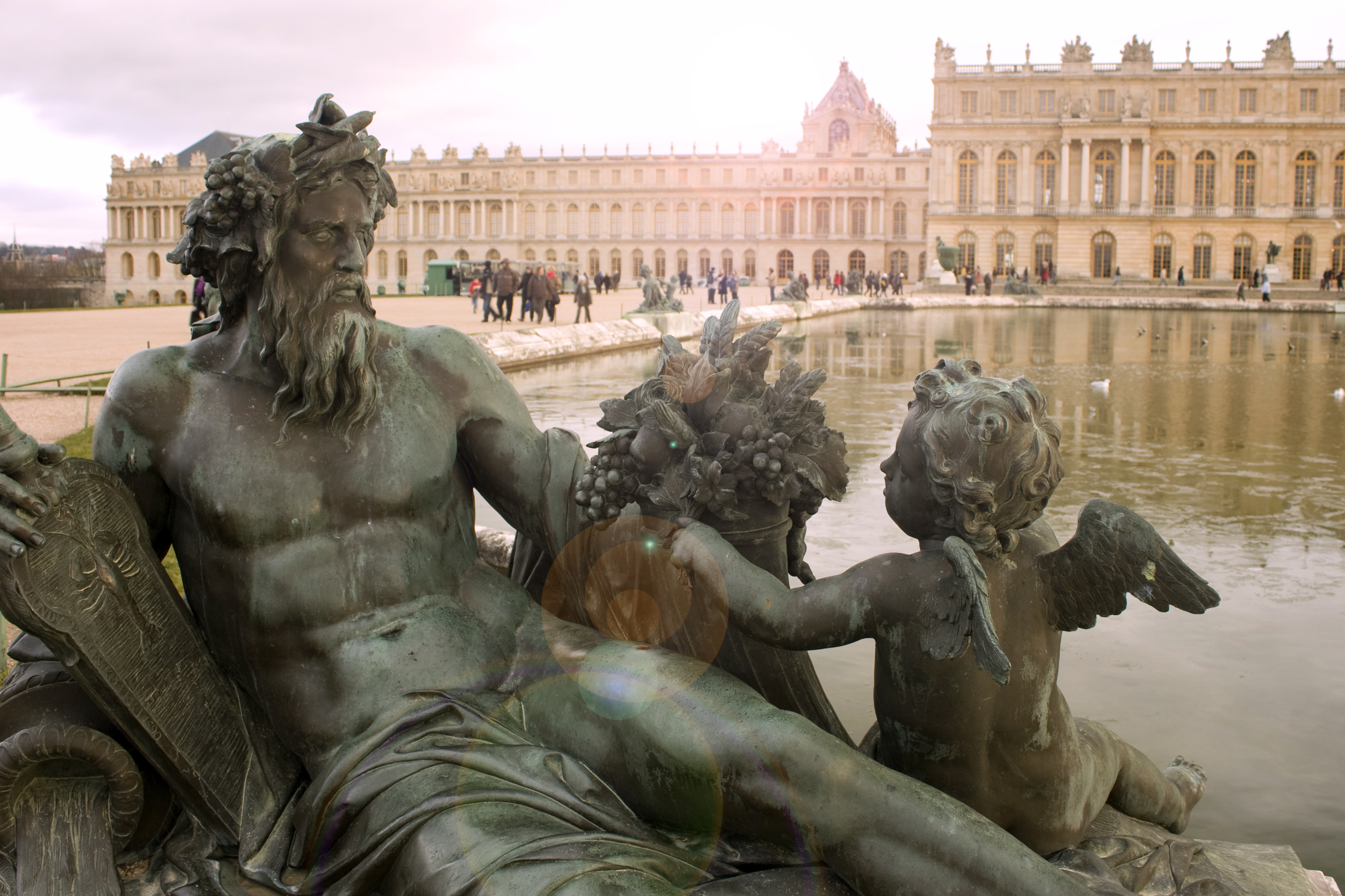 Gardens of Versailles. Statue on the Water Parterre at sunset
