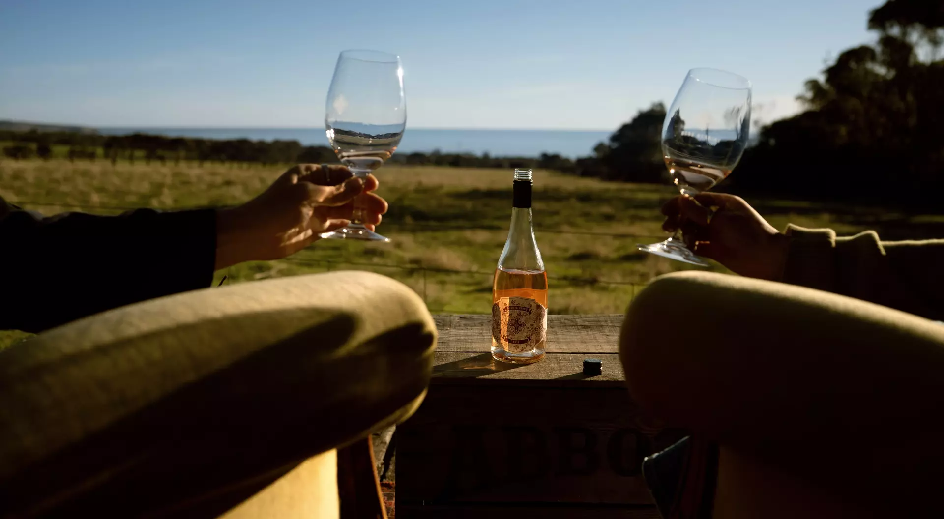 A close up of two glasses during a cheers at the Berg Herring Wines on the Fleurieu Peninsula in South Australia.