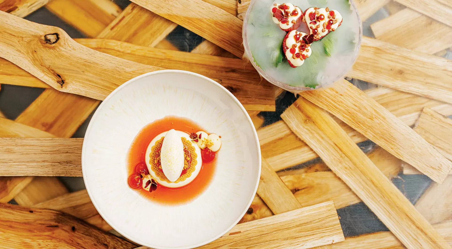 An overhead view of two pristinely prepared dishes of aromatic strawberries at 420 in Prague.