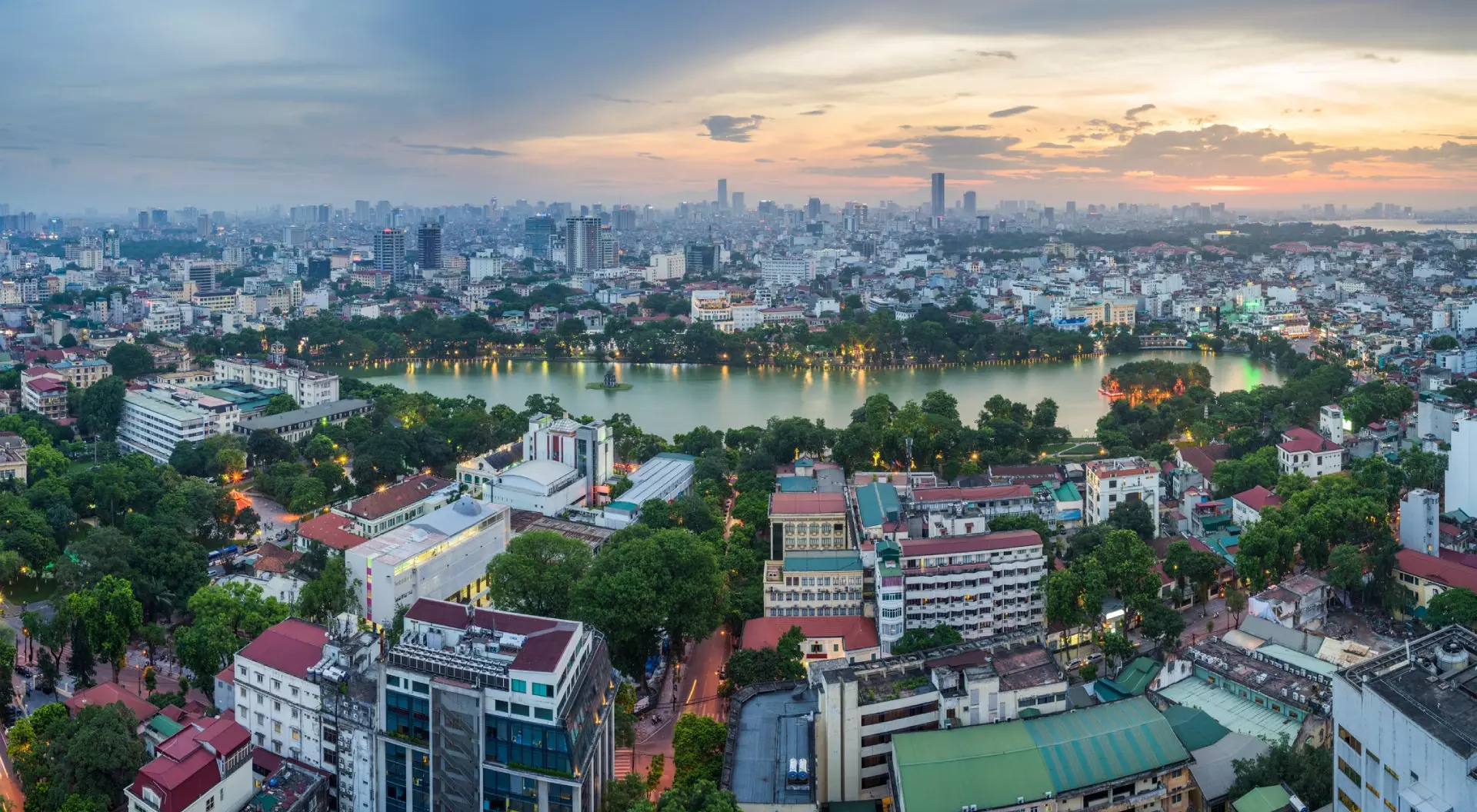 Hanoi, Vietnam Aerial skyline view of Hoan Kiem lake (Ho Guom, Sword lake) area at twilight. Hoan Kiem is center of Hanoi city. Hanoi cityscape