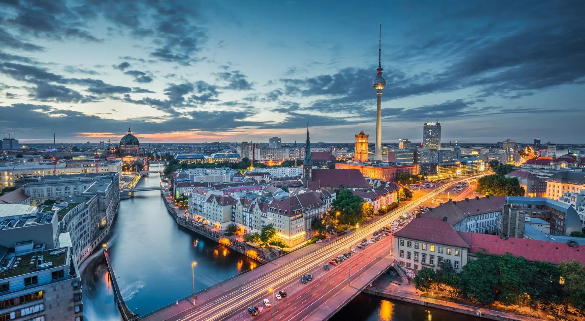 Aerial view of Berlin skyline with dramatic clouds in twilight, Germany