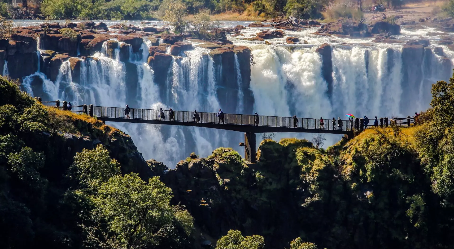 Victoria Falls, Zimbabwe Aerial view of people walking across Victoria Falls, Zimbabwe.