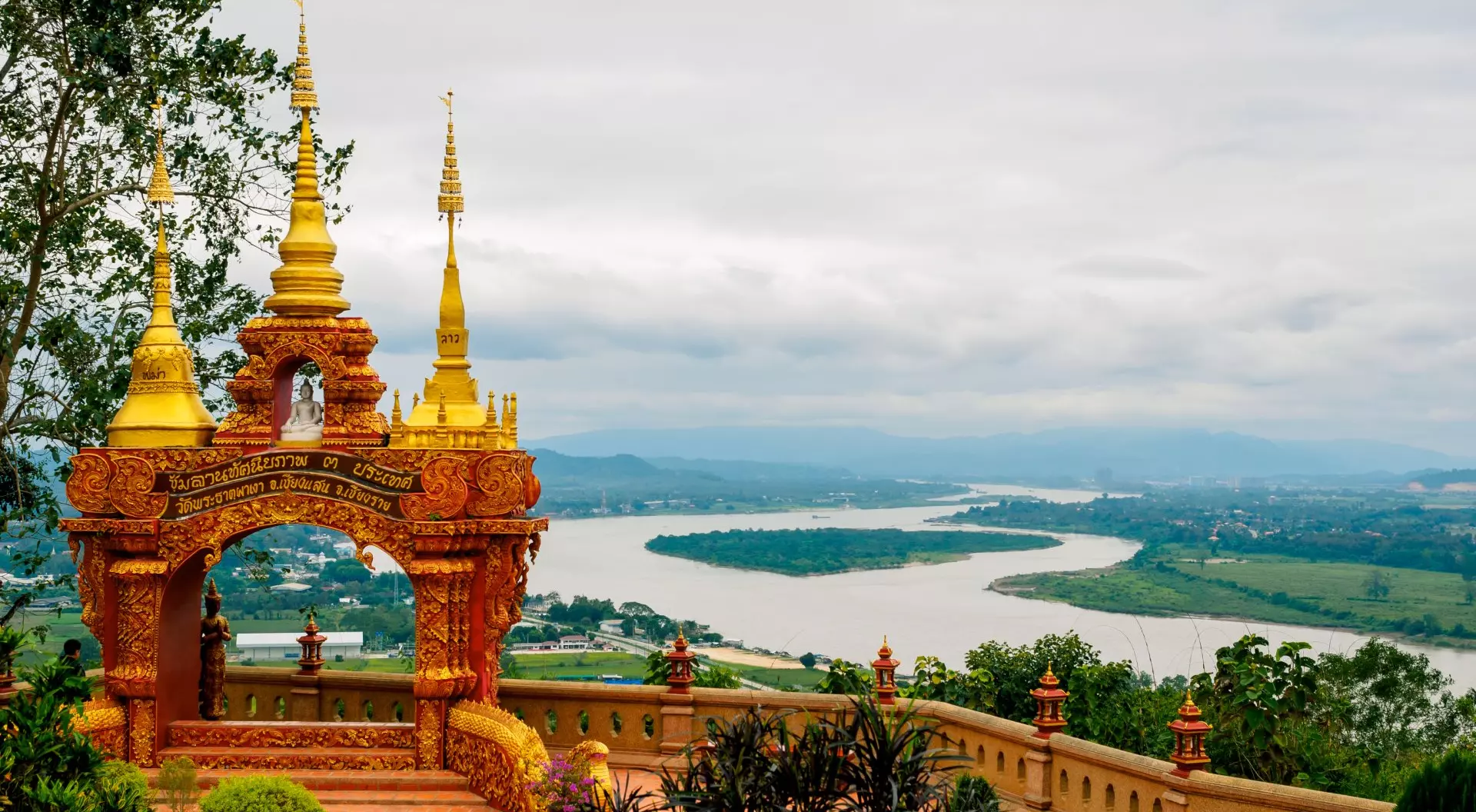 Arch with 3 golden pagodas representing Thailand, Myanmar, Laos at Pra Thad Pha Ngo Temple, Chang Saen, Thailand Vacations