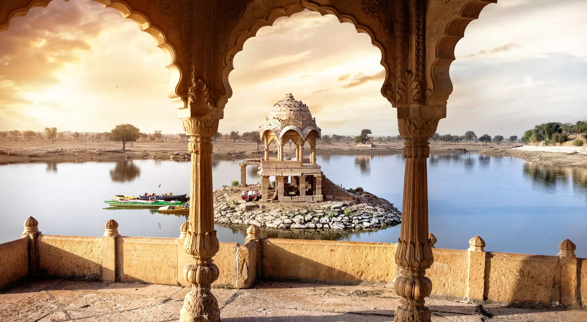 Gadi Sagar Lake, Jaisalmer, India Arches and temple in Gadi Sagar lake at sunset sky in Jaisalmer, Rajasthan, India