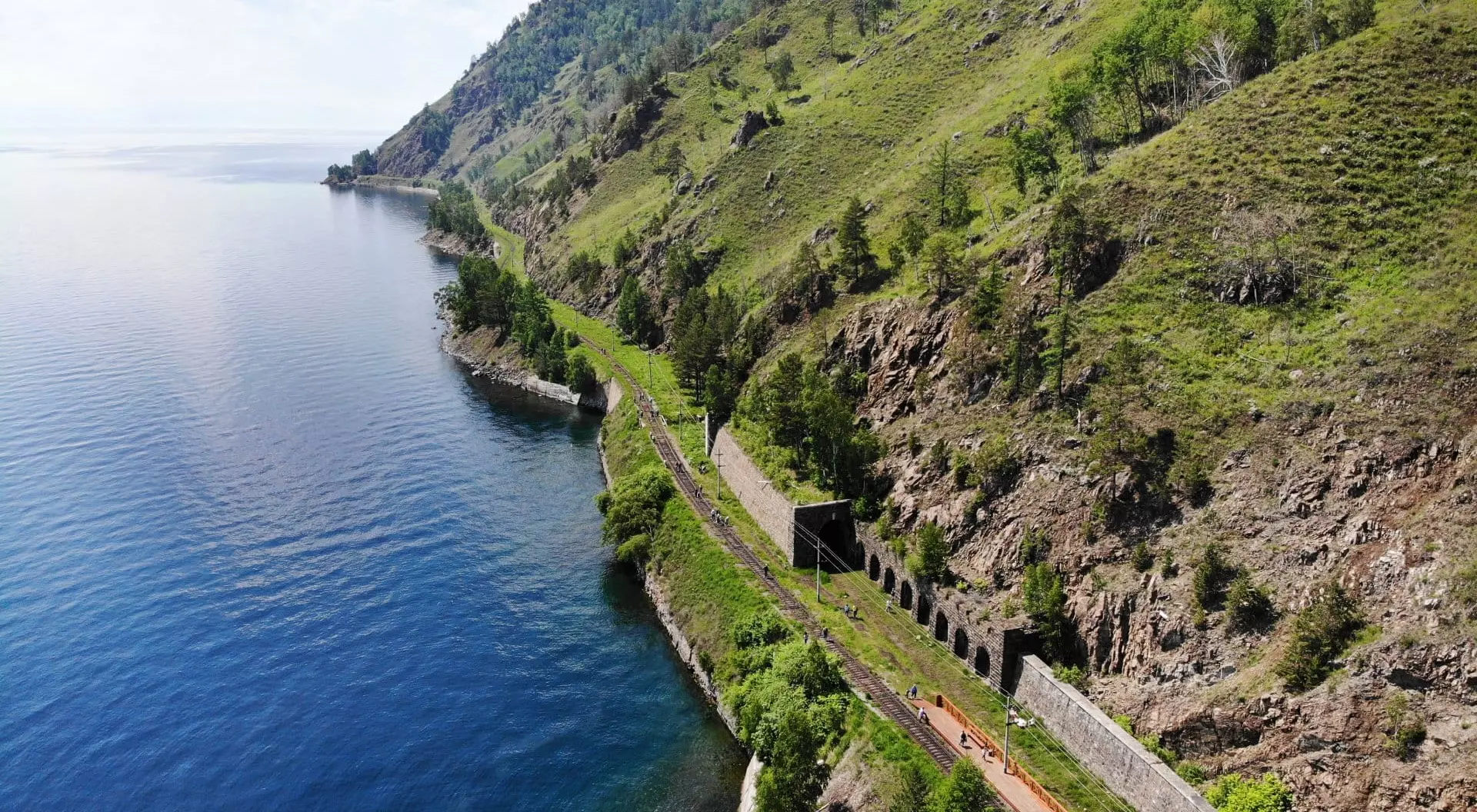 Baikal Lake, Russia Baikal lake. Old stone arch tunnel and stone wall in mountain the rock on the Circum-Baikal railway in summer