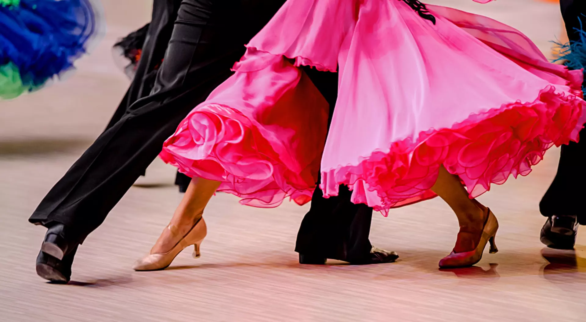 South America Ballroom dancers in black tailcoat and pink ball gown