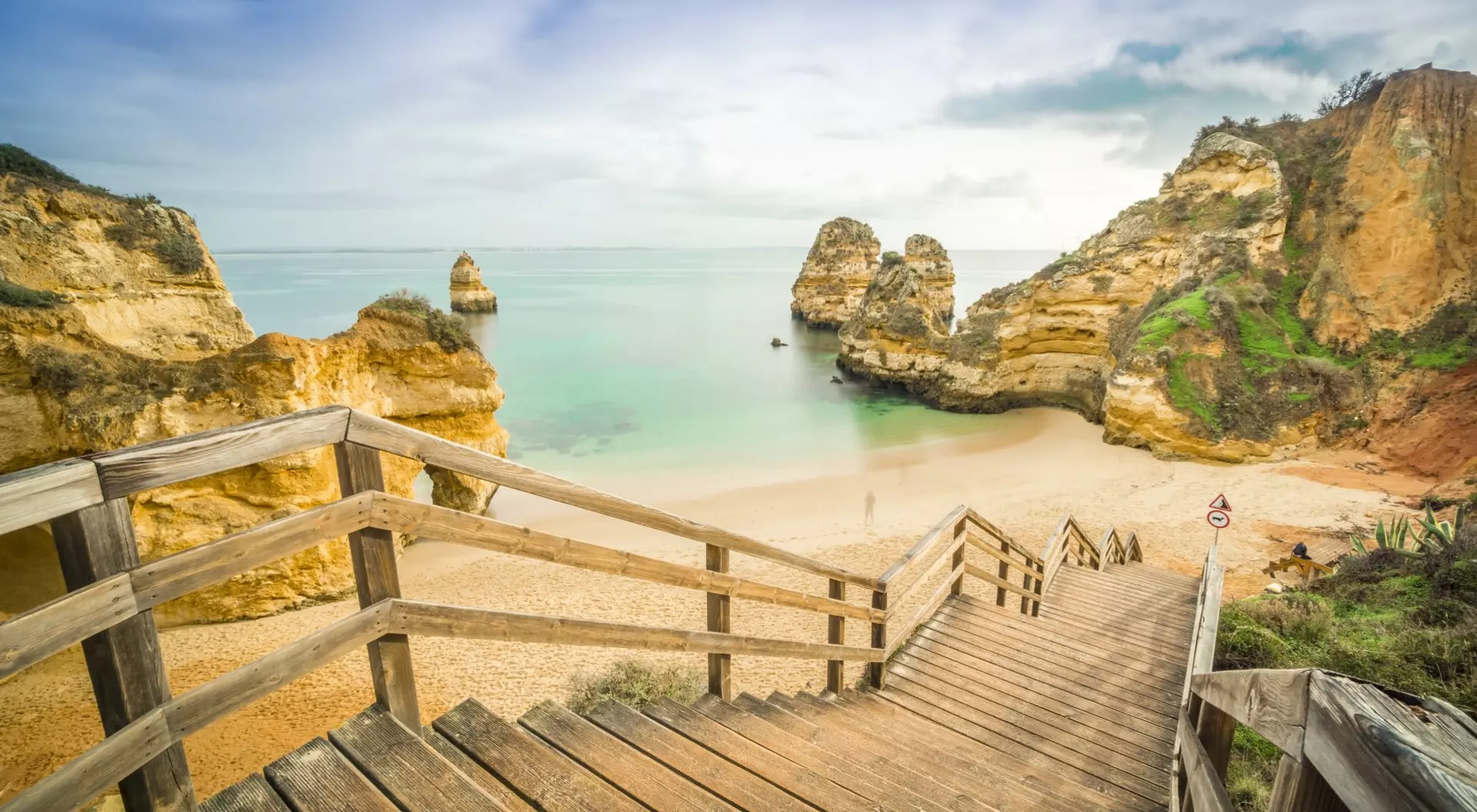 Camilo Beach, Portugal Beautiful Camilo Beach with wooden walkway descending to the sandy beach in Lagos, Algarve, Portugal