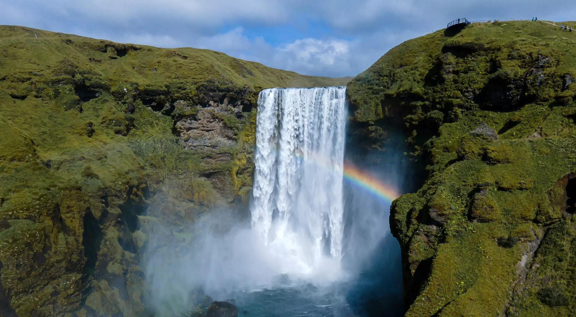 Iceland Beautiful aerial view of the huge Skogafoss waterfall and its rainbow in summer.