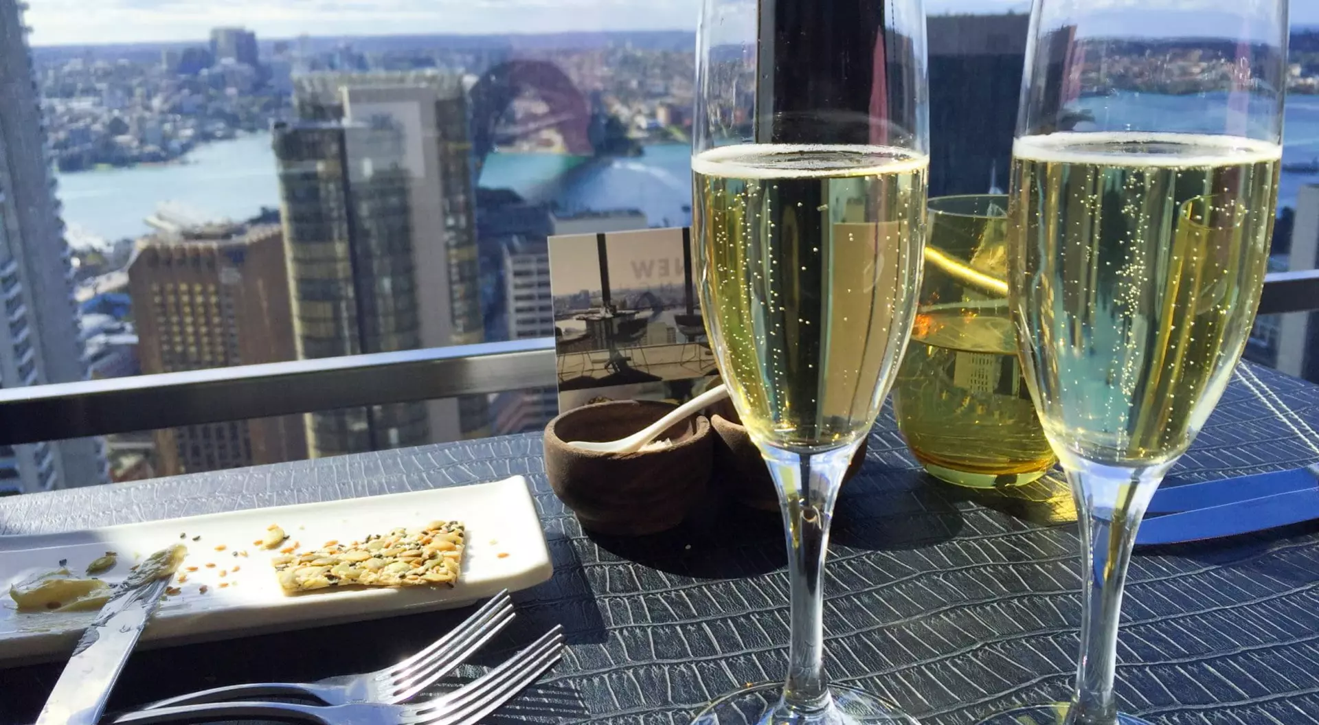 Champagne and a snack in a high rise building.