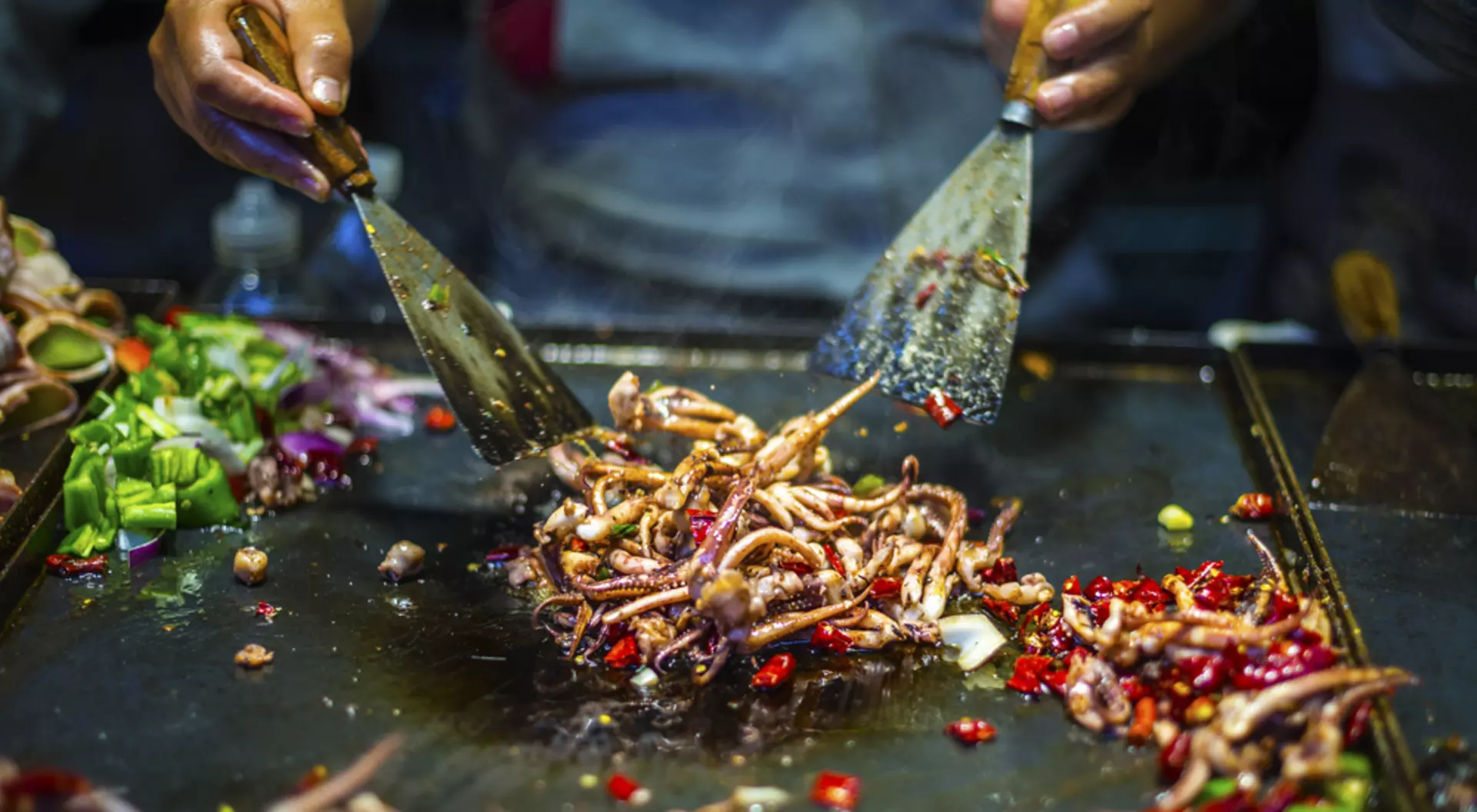 Chef making iron squid in old town of Lijiang, Yunnan Province, China Holidays