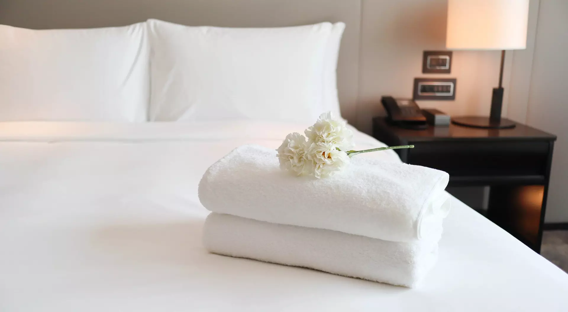 Clean white bath towels on the neatly clean bedroom - coziness and clean