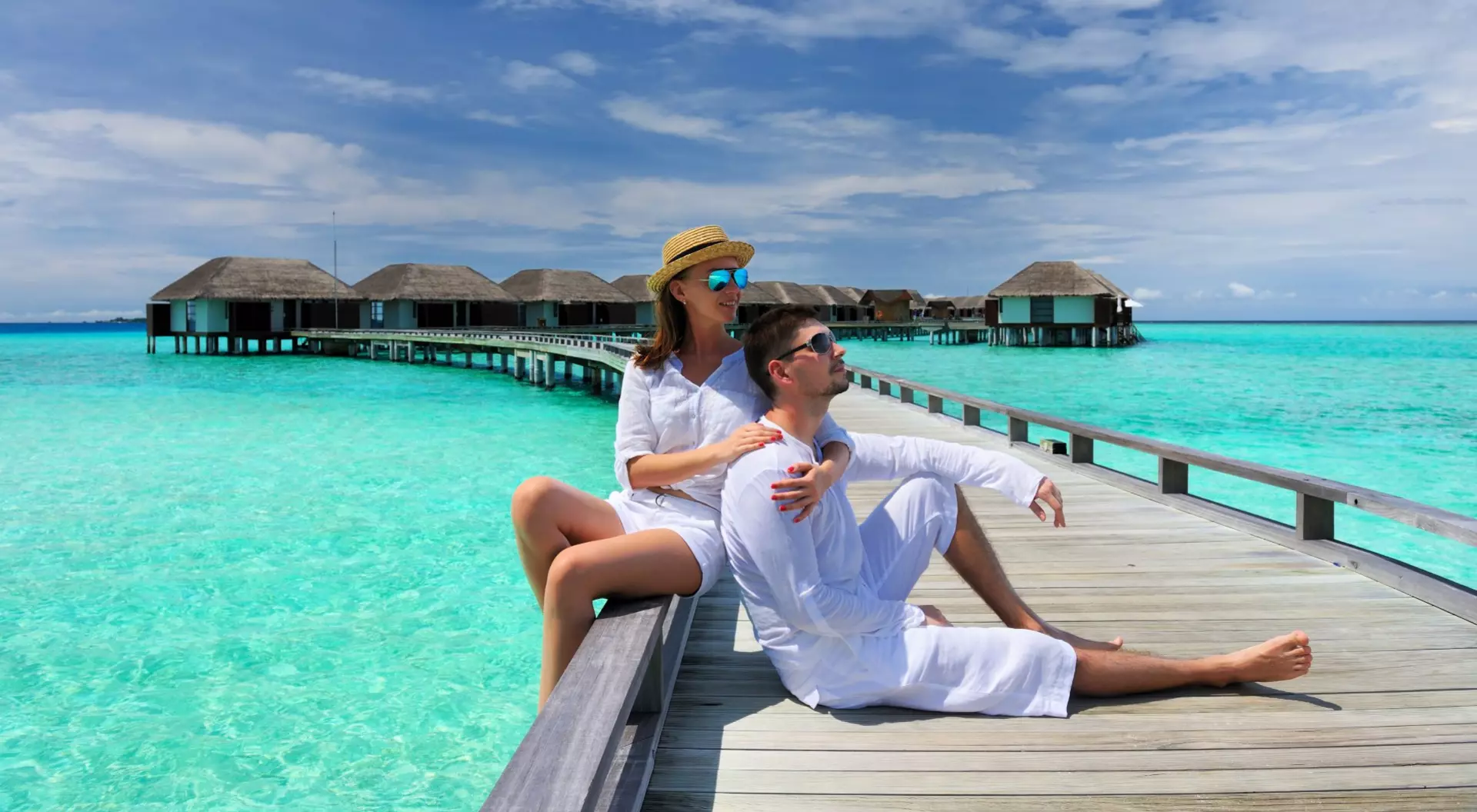 Couple on a Tropical Beach Jetty, Maldives