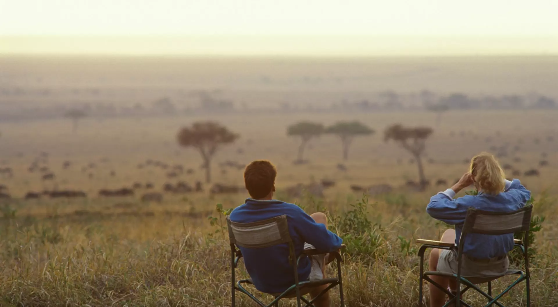  Couple relax in armchairs on the savannah