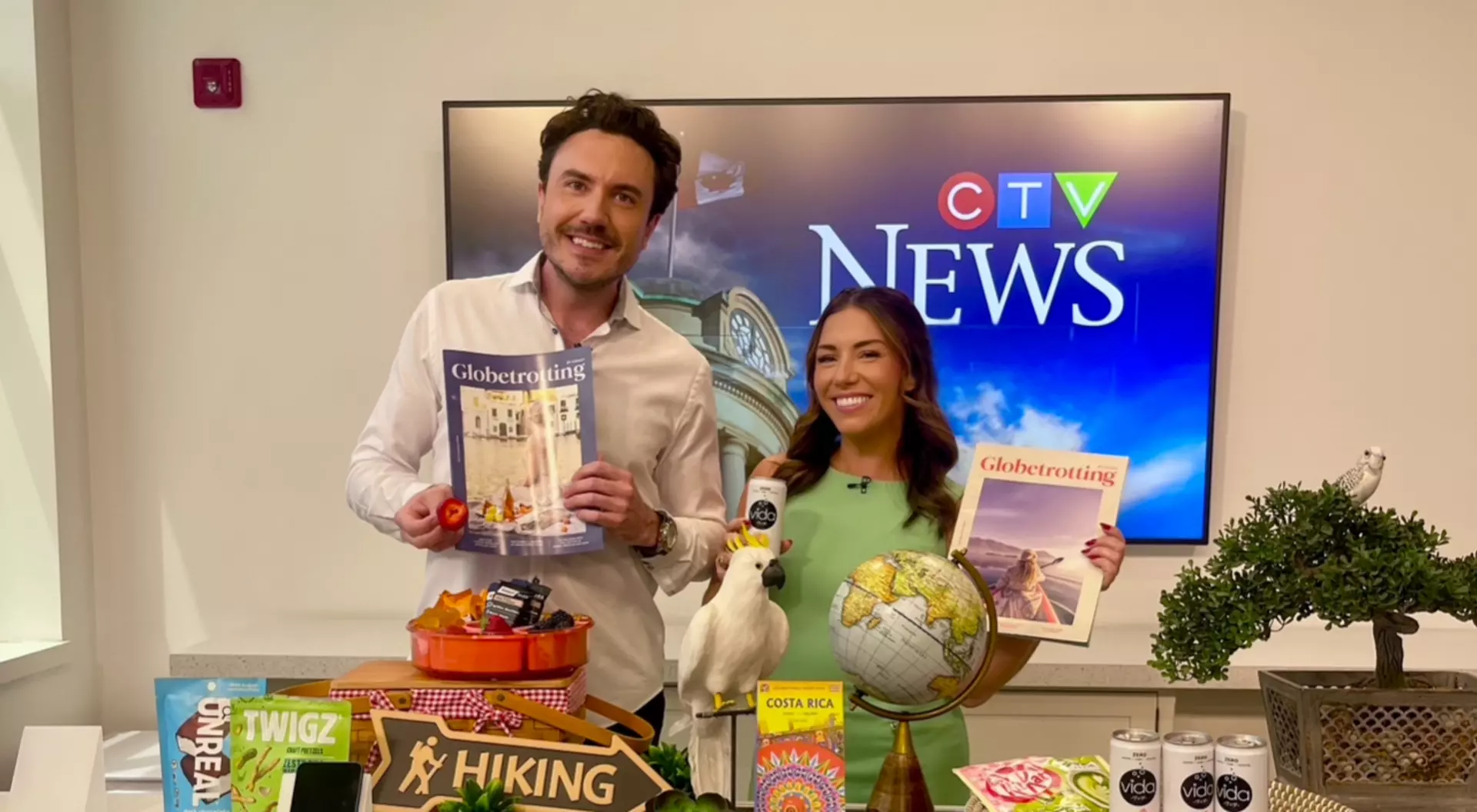 Mitchell Fawcett and Leighanne Evans of CTV News smiling together before their live news segment.