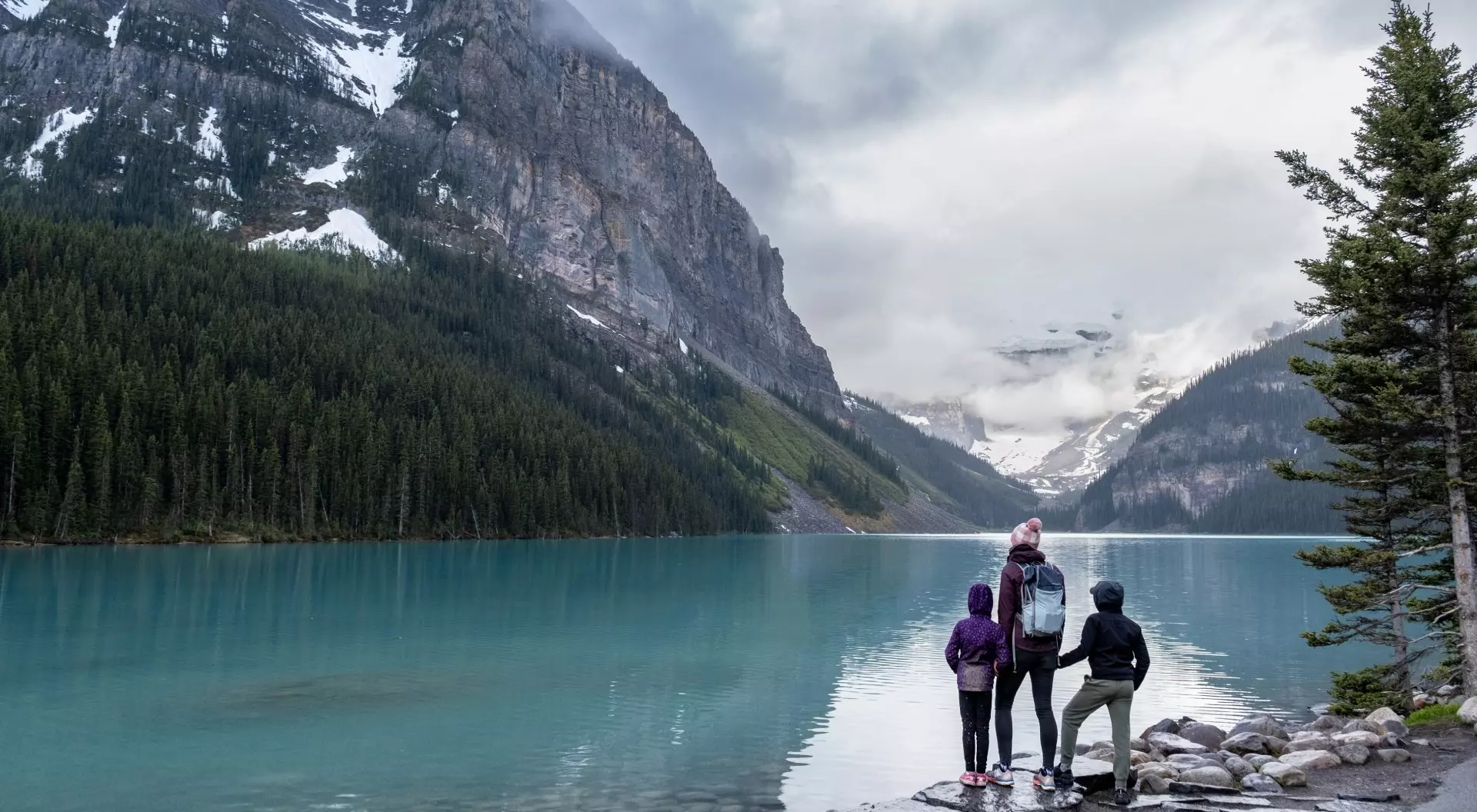 Banff National Park, Canada Family hiking around a pristine glacial lake in Banff National Park, Canada.