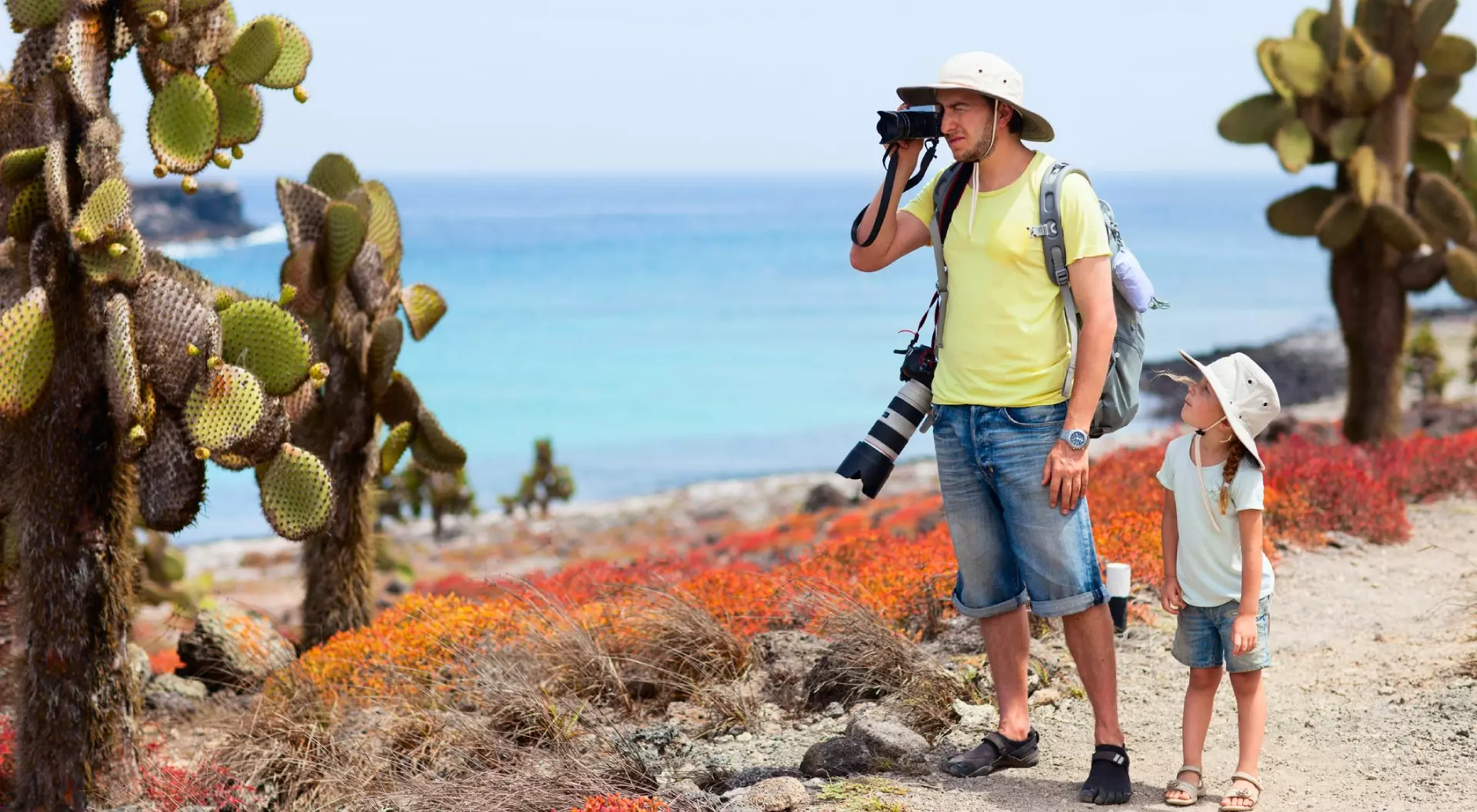 Father and daughter at scenic terrain on Galapagos South Plaza island