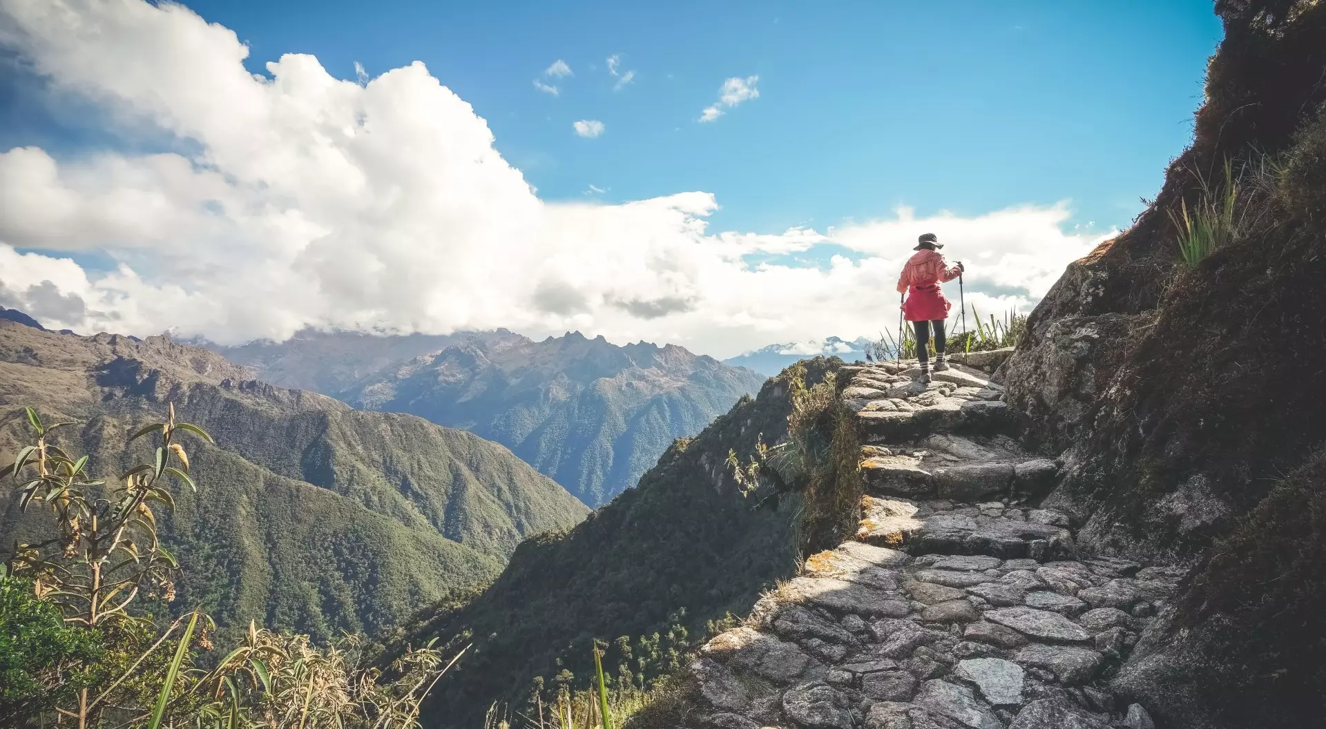Female hiker walking towards Machu Picchu on the famous Inca Trail, Sacred Valley, Peru