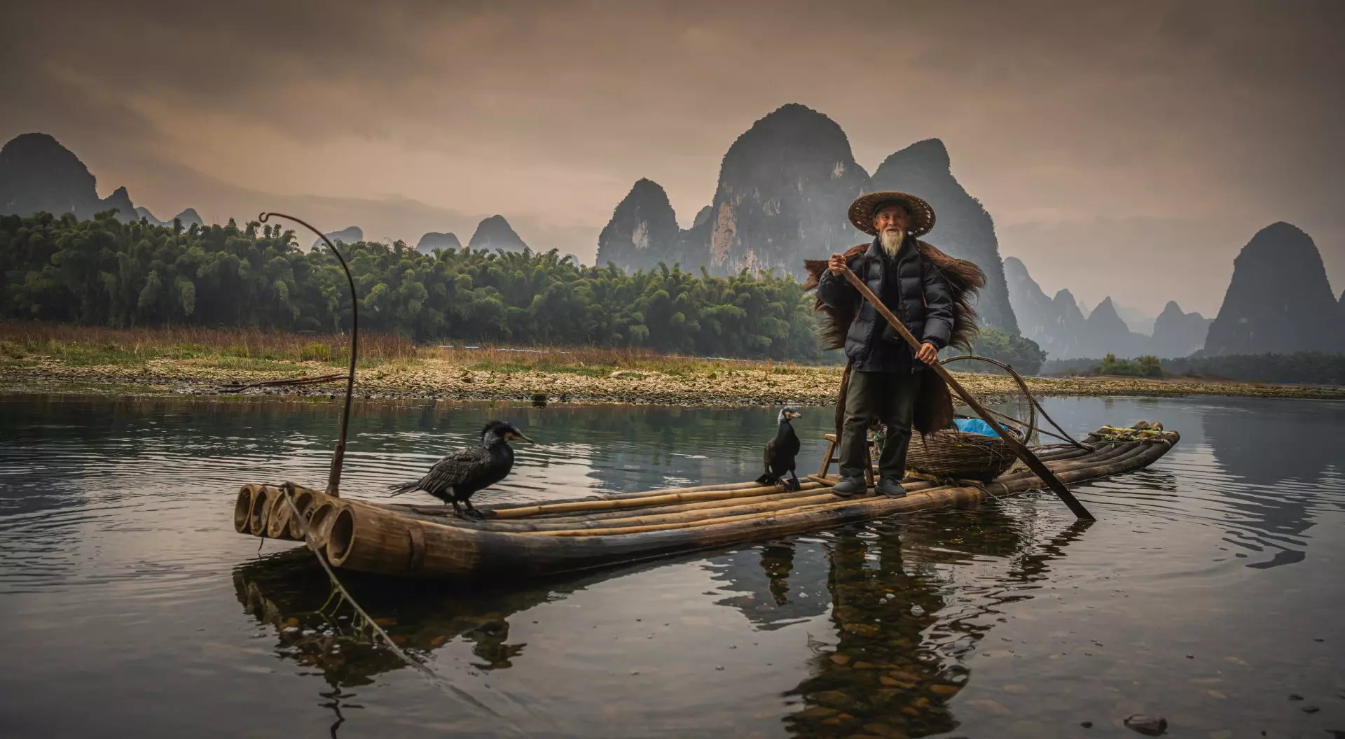 Fisherman of Guilin, Li River and Karst mountains during the blue hour of dawn, China