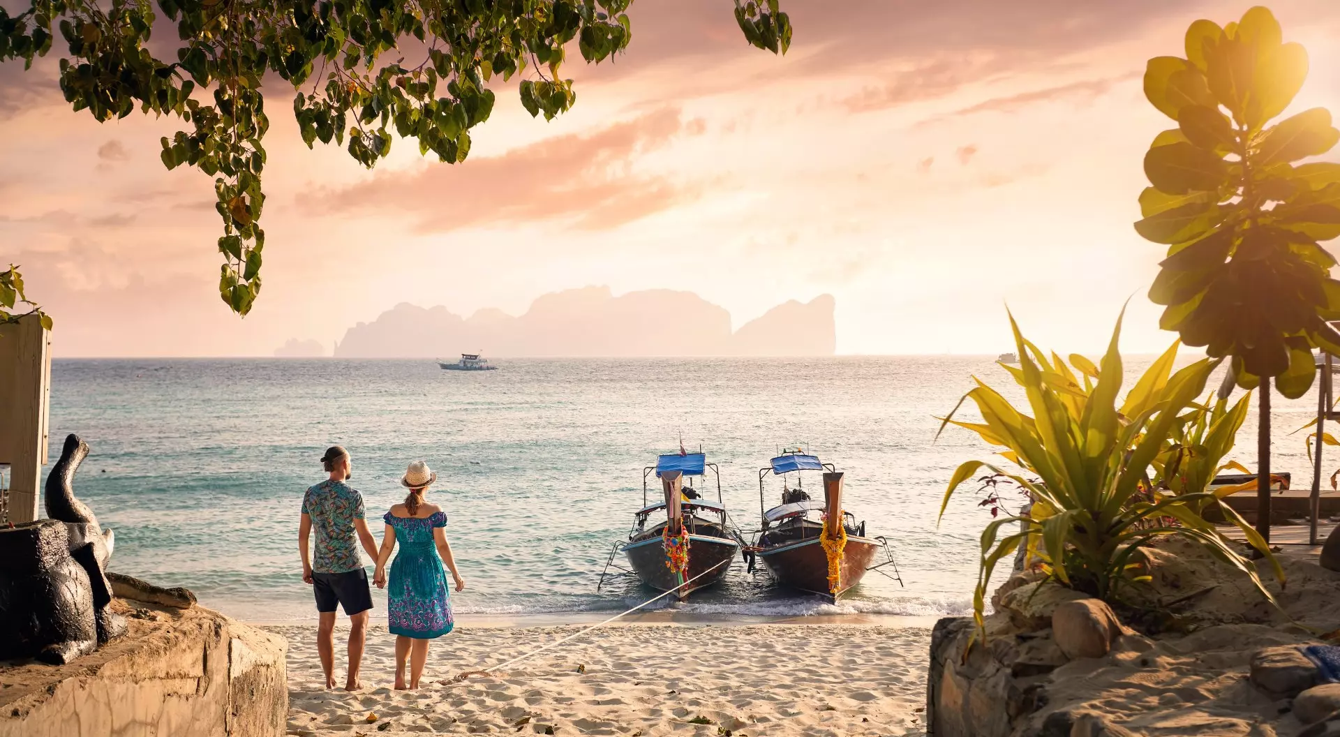 Koh Phi Phi, Thailand Happy couple on the tropical beach of Phi Phi island at sunset in Southern Thailand.