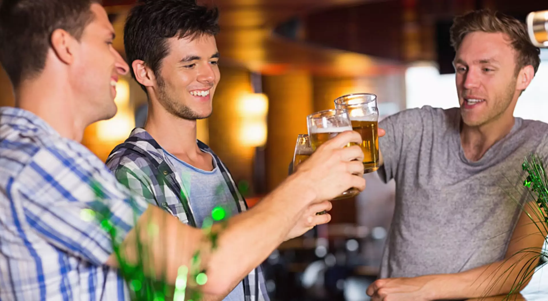 Ireland Happy Male Friends Toasting with Beer on St Patricks Day in a Bar