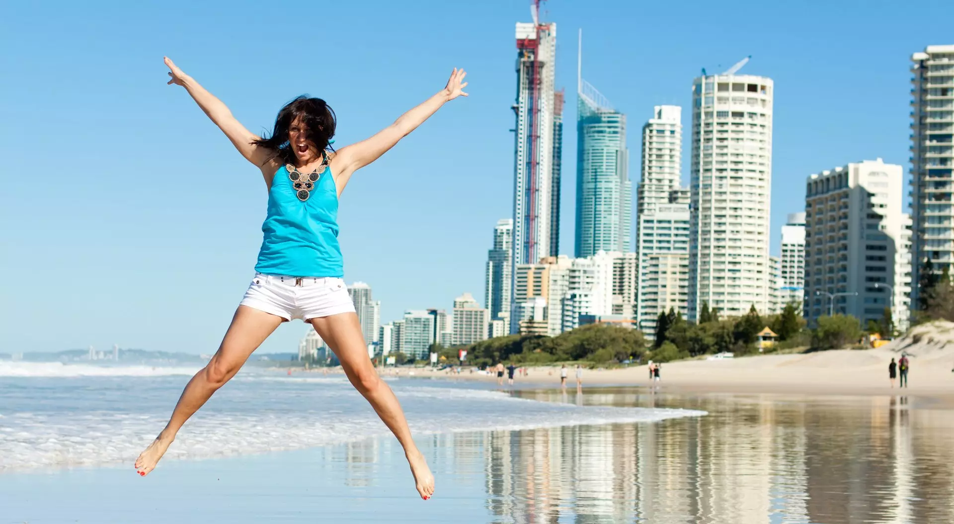 Queensland, Australia Happy Woman Jumping for Joy on Beach Along the Gold Coast, Queensland, Australia