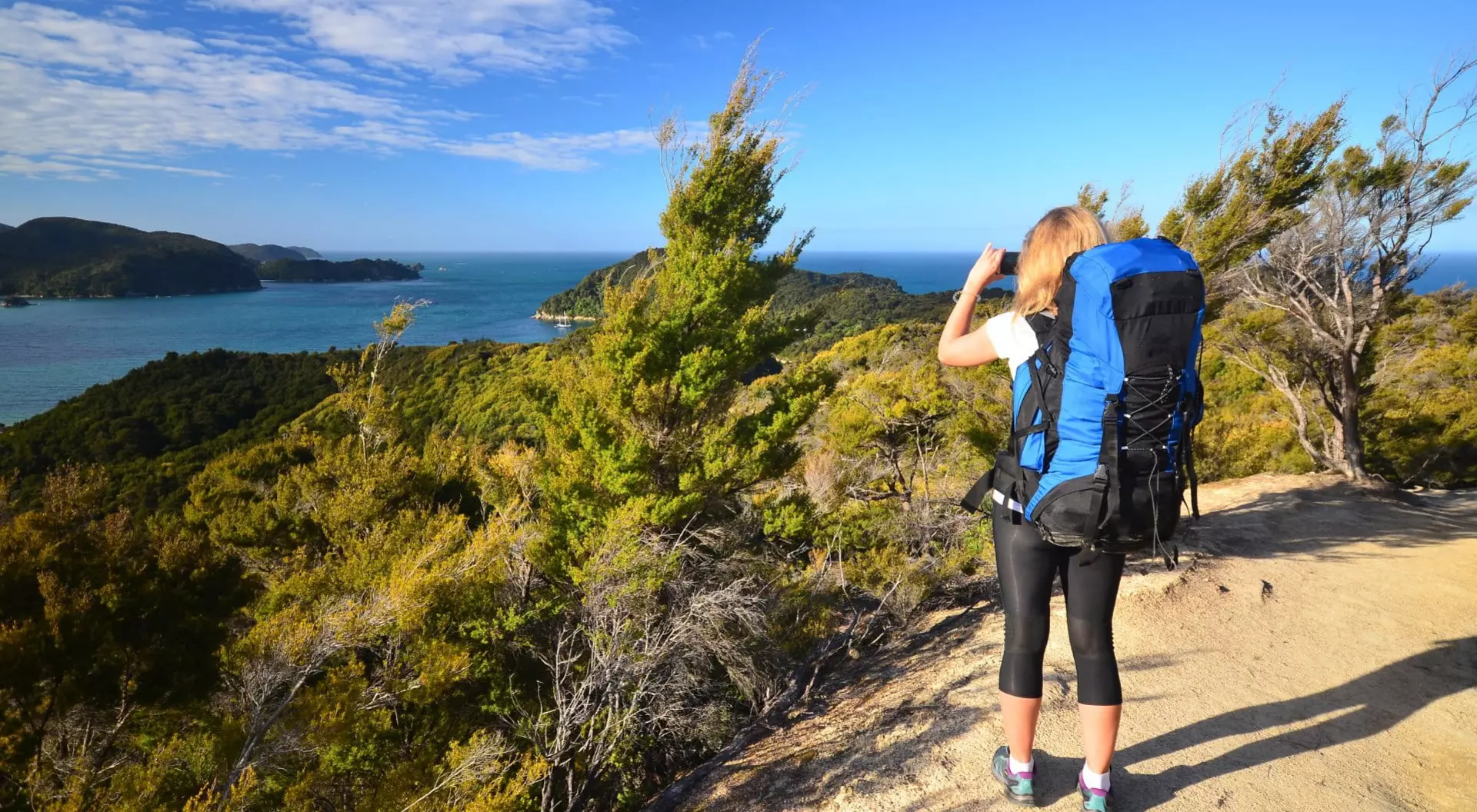 Hiker taking picture in Abel Tasman National Park