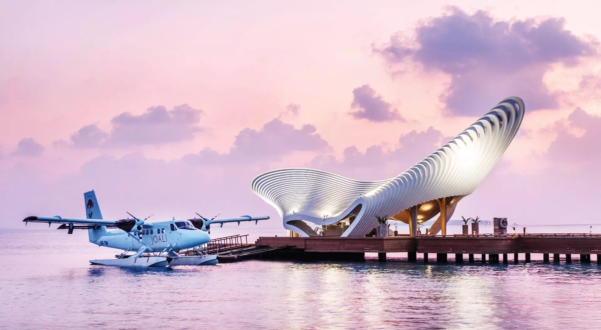 view of a plane landing on the water at the elaborate doc of a futuristic resort in the Indian Ocean in the Maldives