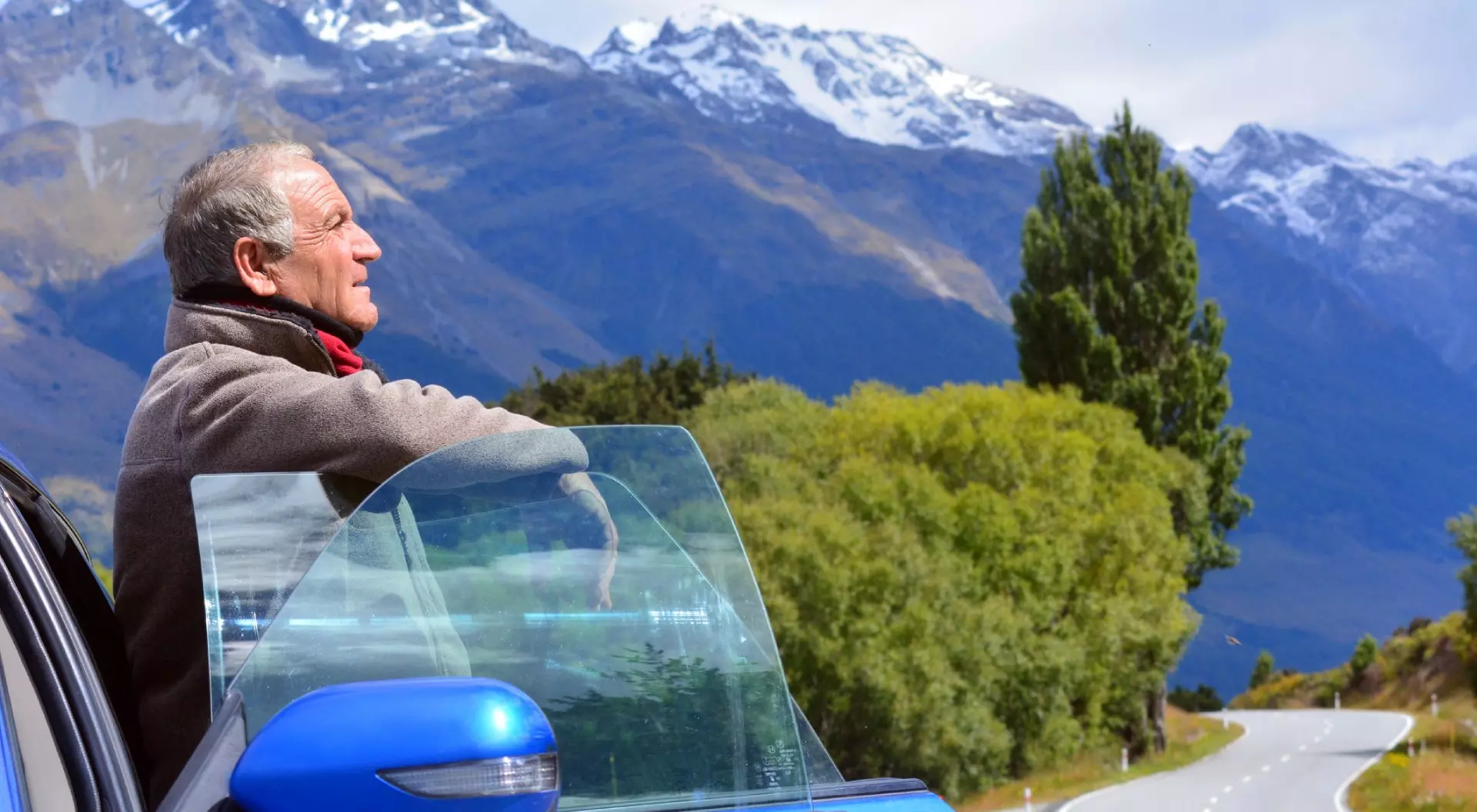 Mature Man Standing at Side of the Road Near Car Admiring Nature New Zealand
