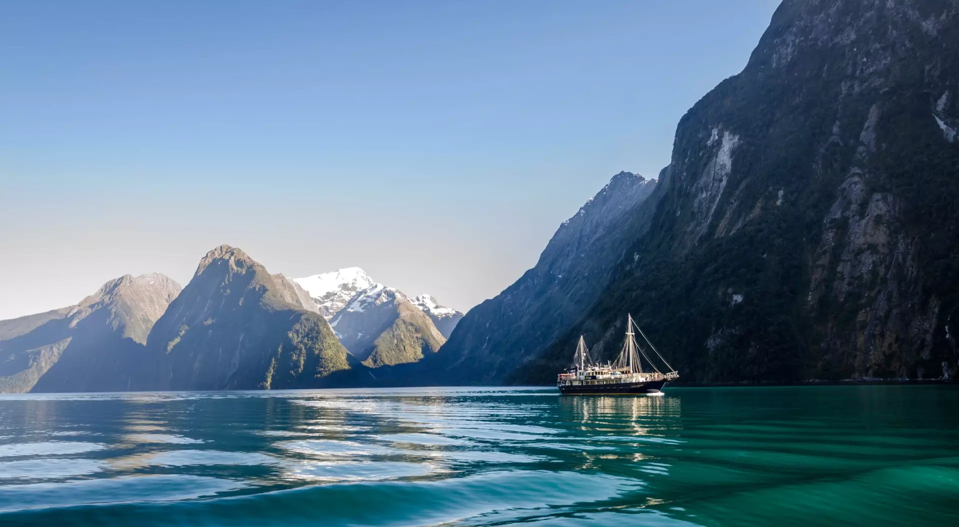 Milford Sound, New Zealand Milford Sound with Cruise ship during sunrise during early morning