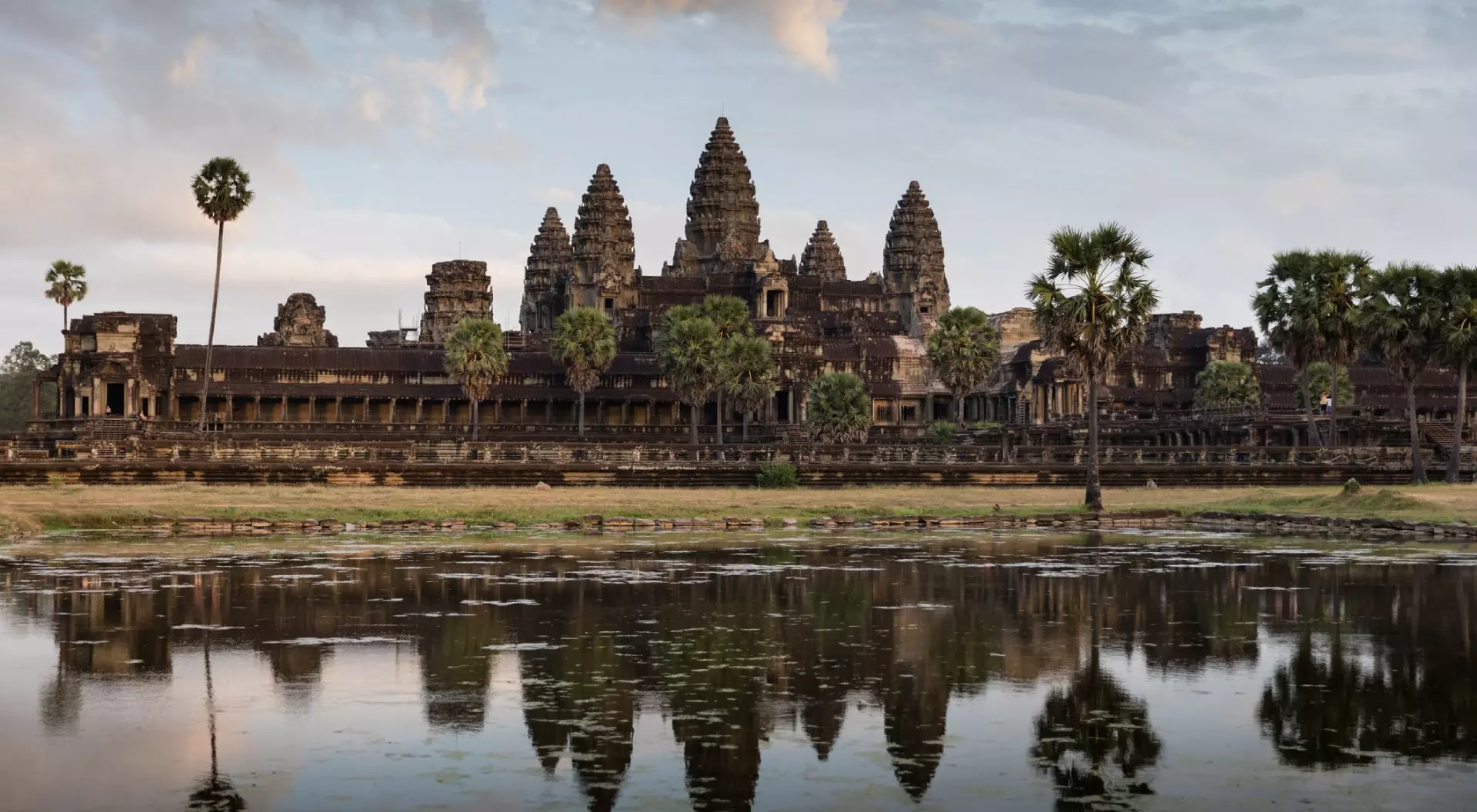 Monumental Angkor Wat Temple in early morning light after sunrise under beautiful cloudy sky. Angkor Wat, Siem Reap, Cambodia