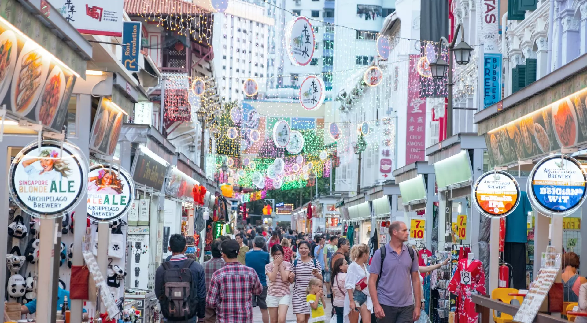 Singapore Singapore, Chinatown - People walking and shopping on the street market after sunset.